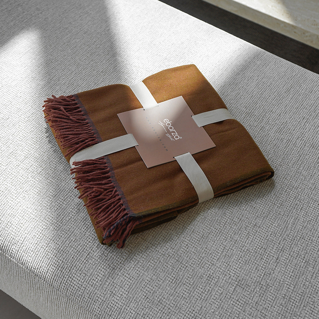 BEACON CozyNest Throw Blanket in 260GSM, soft and warm, shown draped over a cozy armchair for comfortable home decor.