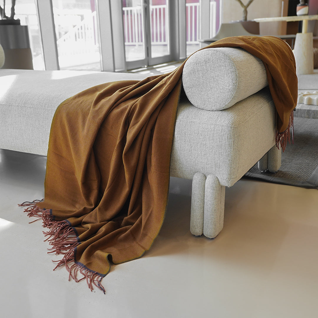 BEACON CozyNest throw blanket in 260GSM soft, plush fabric, draped over a cozy sofa for warmth and comfort.