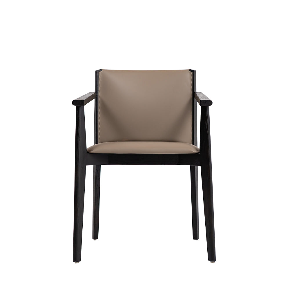 Dark saddle leather arm dining chair with wooden legs, designed by BEACON, showcasing a stylish and comfortable seating option.