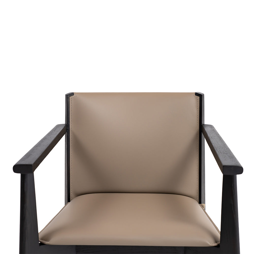 Dark saddle leather arm dining chair with wooden legs, modern design, and cushioned seat for comfortable dining room seating.