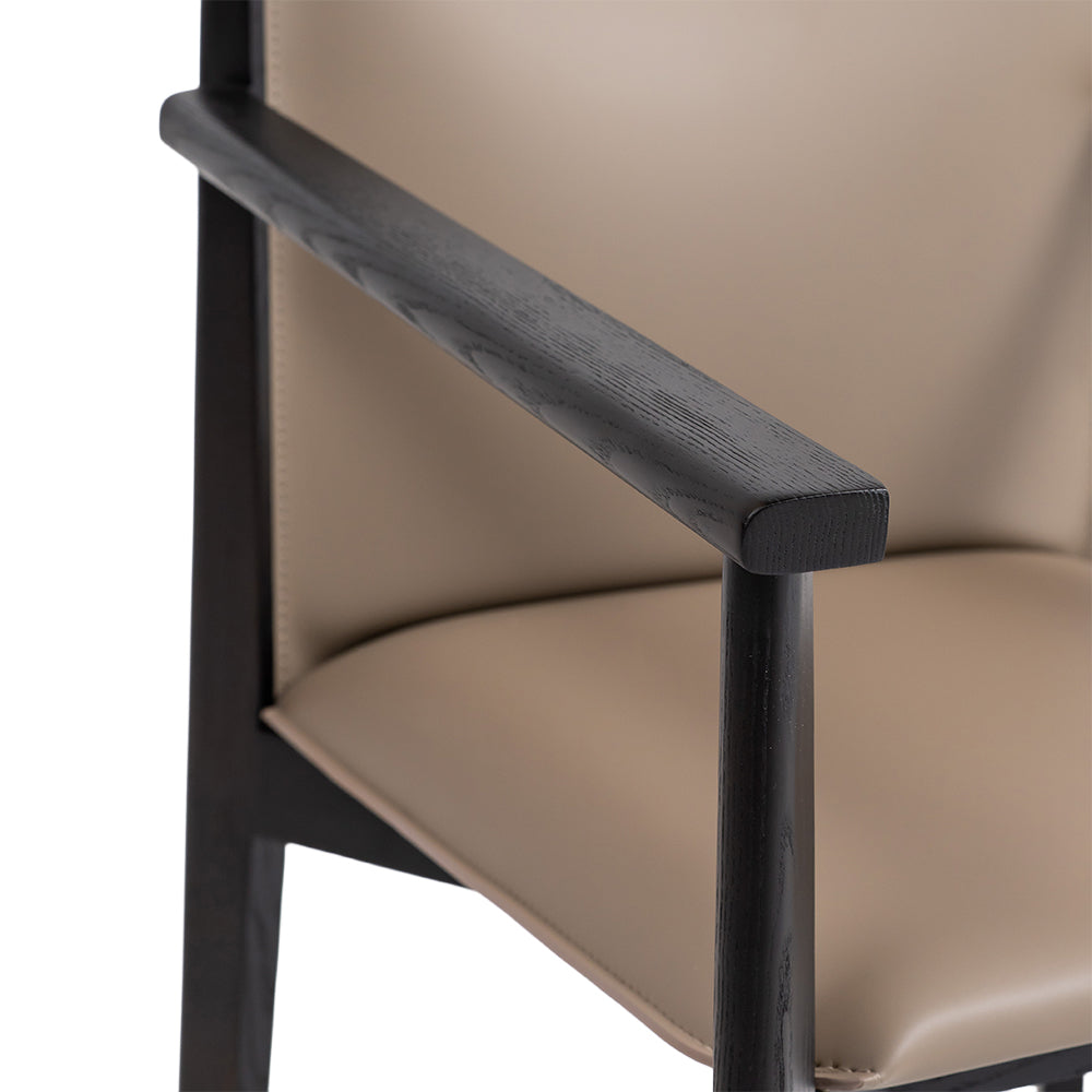 Dark saddle leather arm dining chair with wooden legs, modern design, comfortable padded seat and stylish armrests by BEACON.