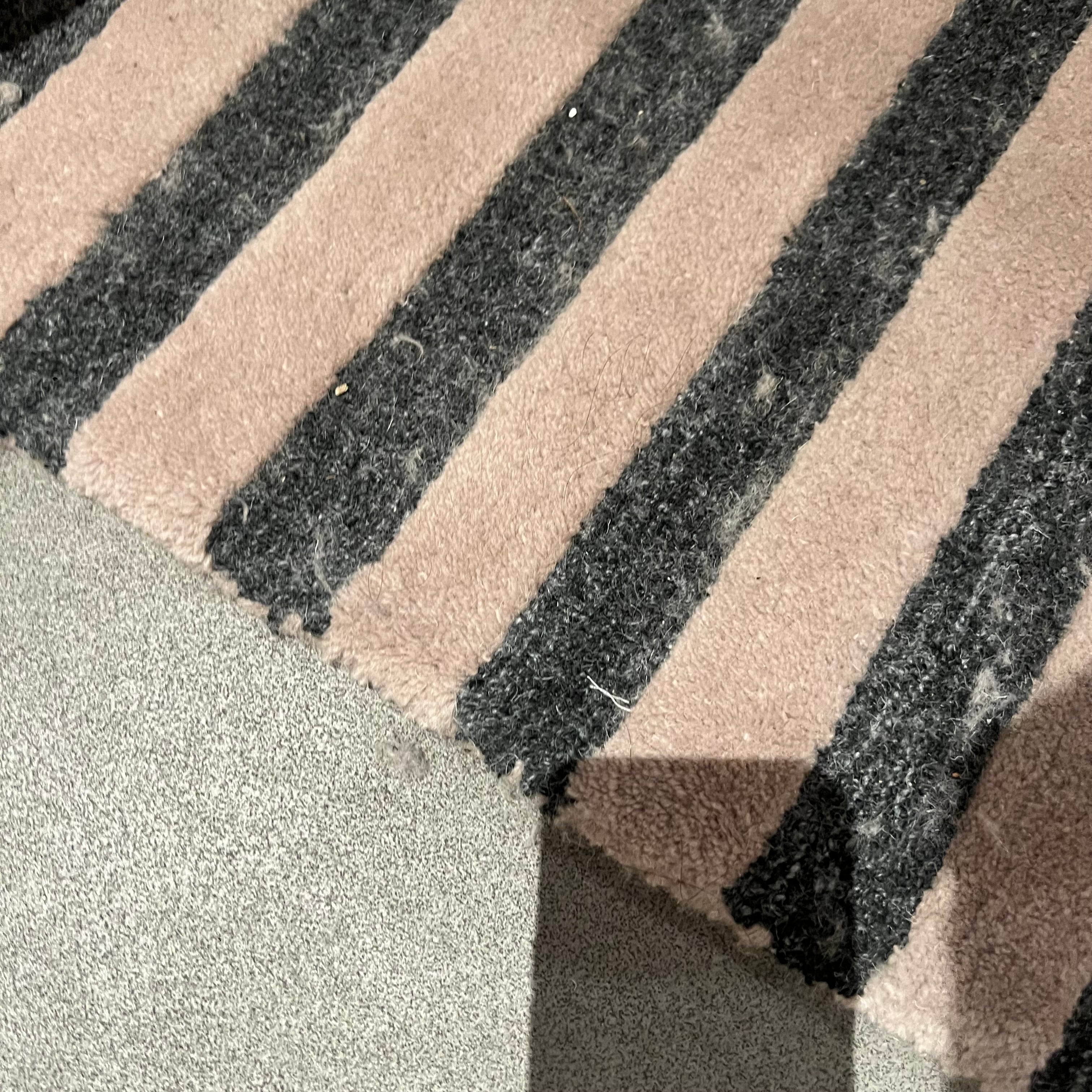 Display Javi wool beige and brown rug, 450x300 cm, with intricate pattern, showcasing soft texture and elegant design.