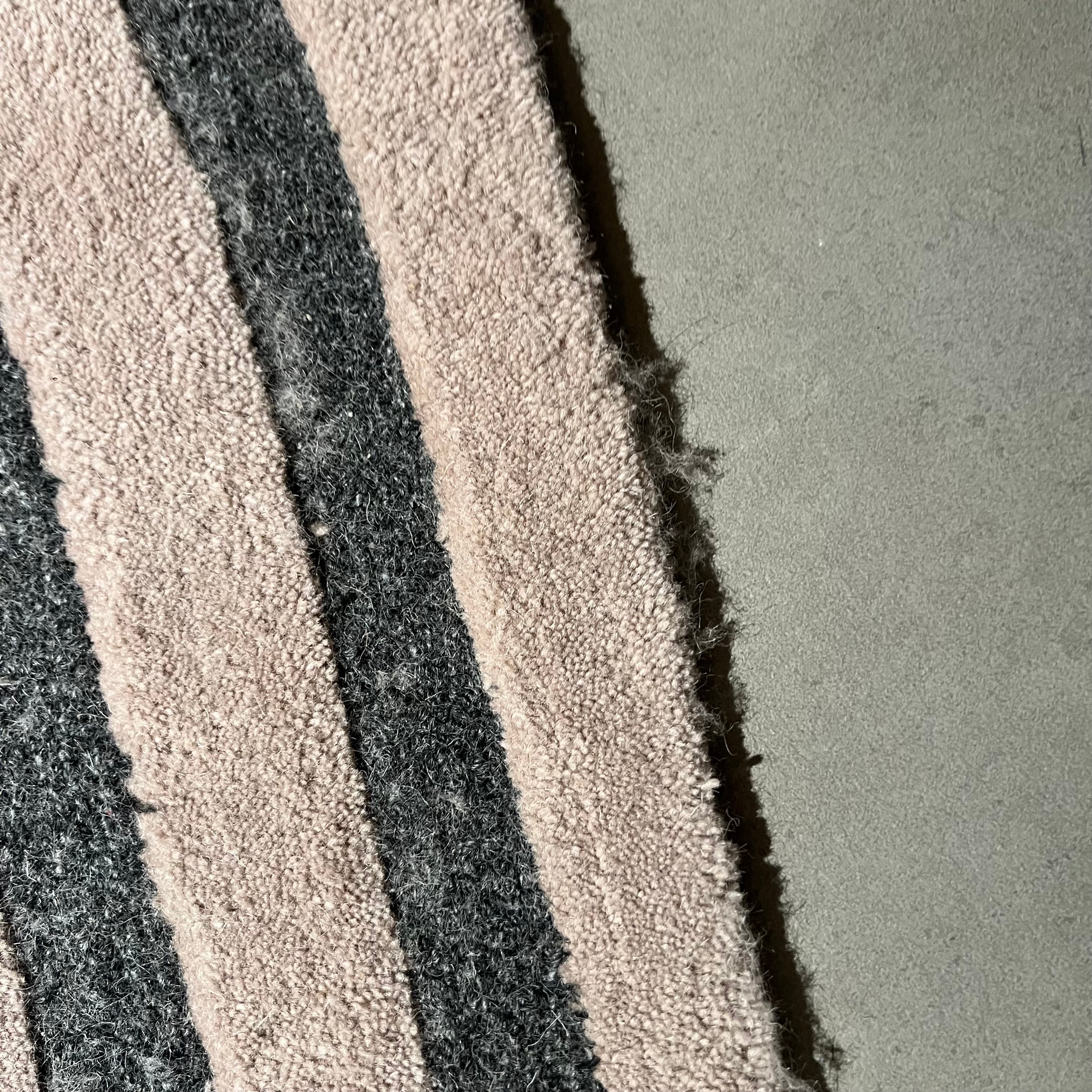 Display image of a 450x300 cm beige and brown wool rug by Javi, featuring a soft, textured surface and intricate pattern.