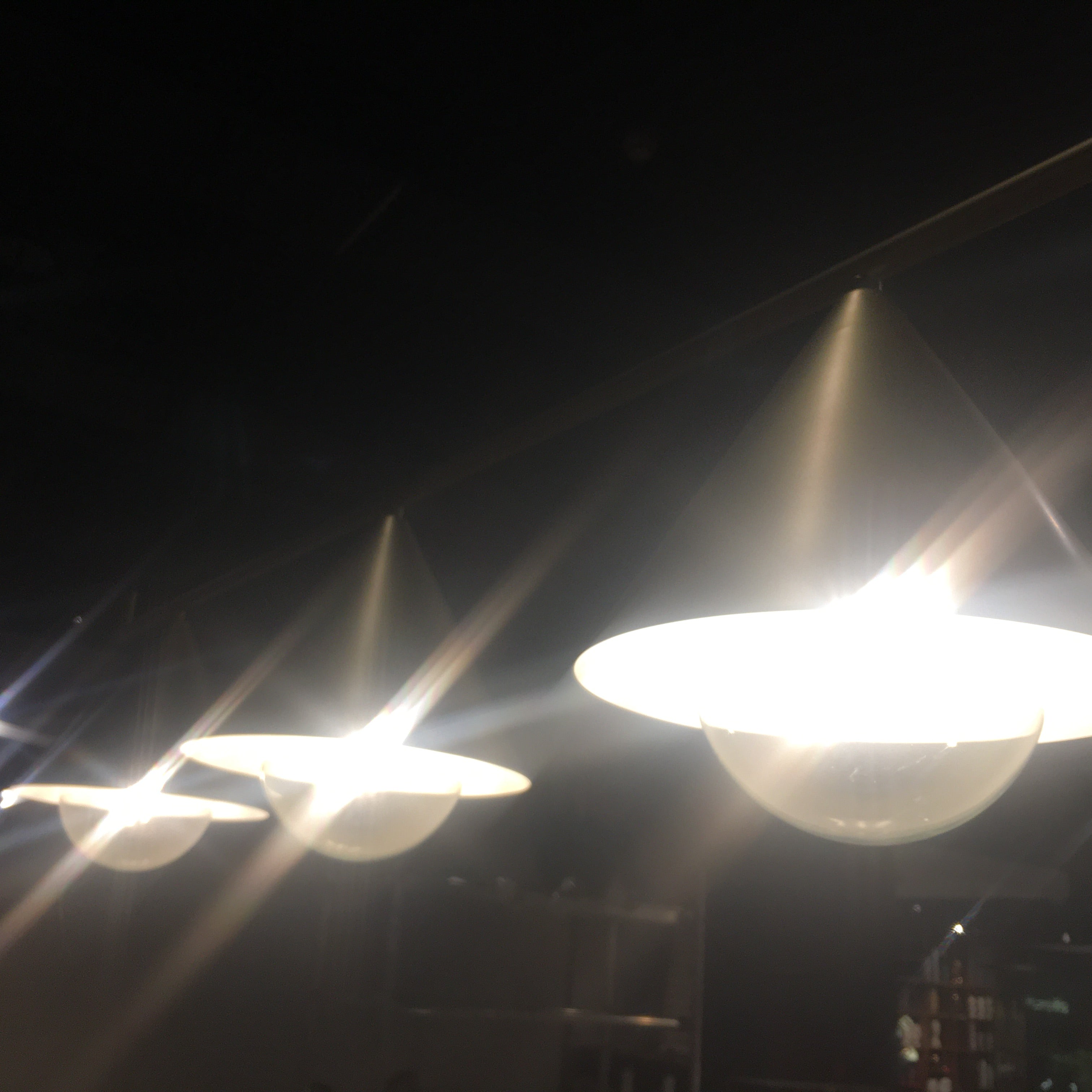 Display of the Andria 3 Heads Pendant Lamp by Beacon, showing its modern design and three hanging light fixtures.