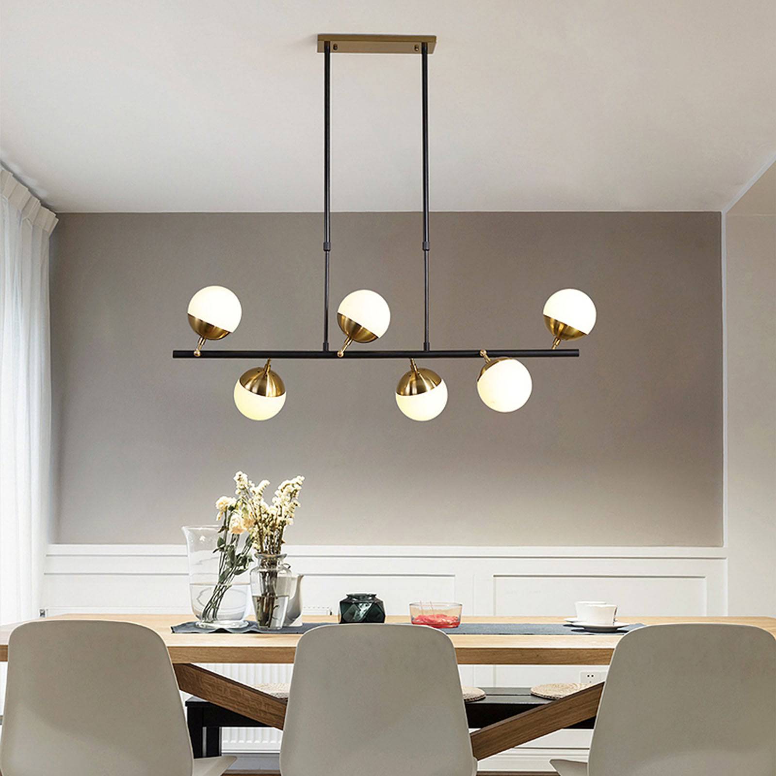 Display of Arvika 6-heads pendant lamp by BEACON, showcasing modern design with six hanging light fixtures.