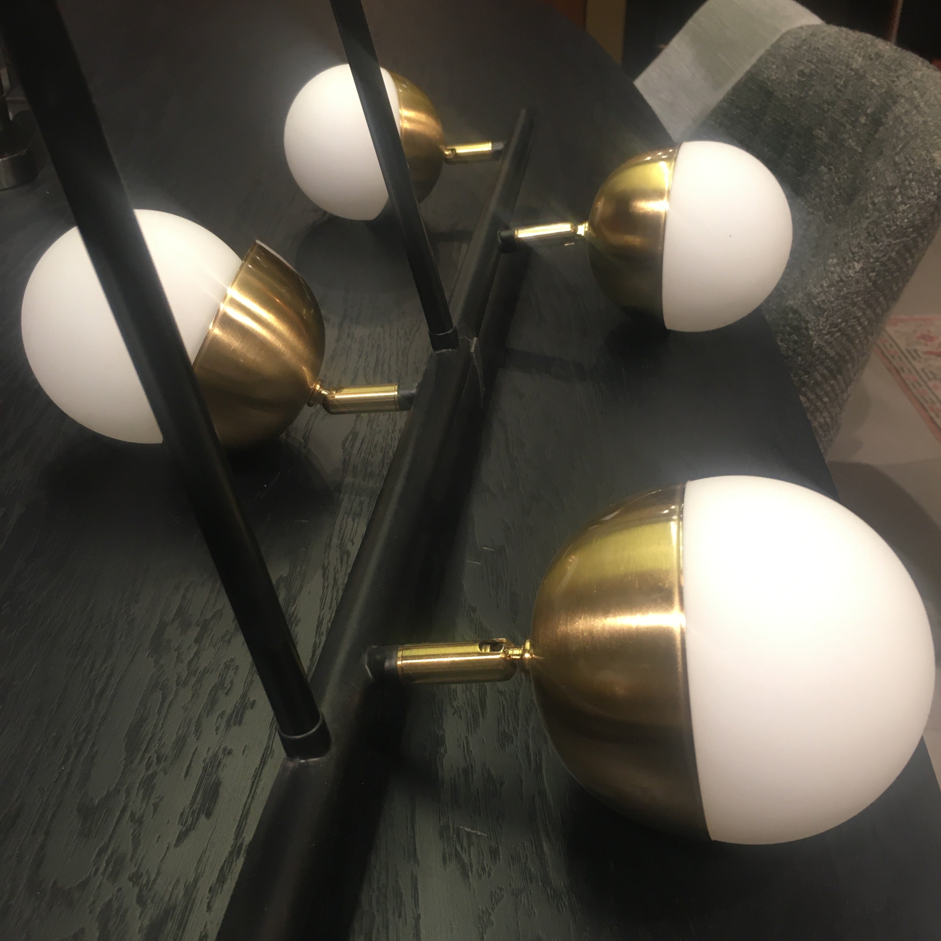 Display of the Arvika 6-heads pendant lamp by BEACON, featuring modern design with multiple hanging light fixtures.