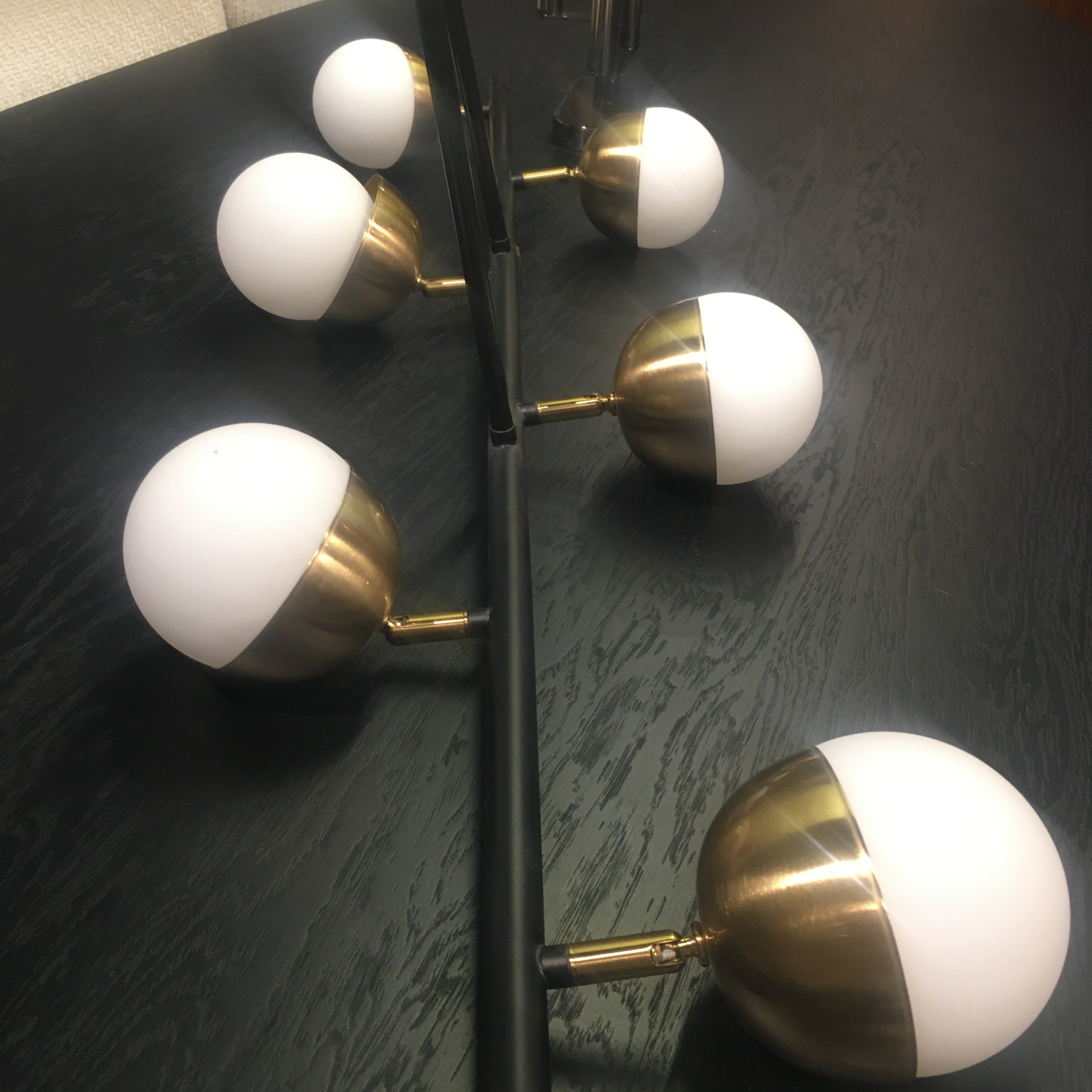 Display of the Arvika 6-heads pendant lamp by Beacon, showcasing its modern design and multiple hanging light fixtures.