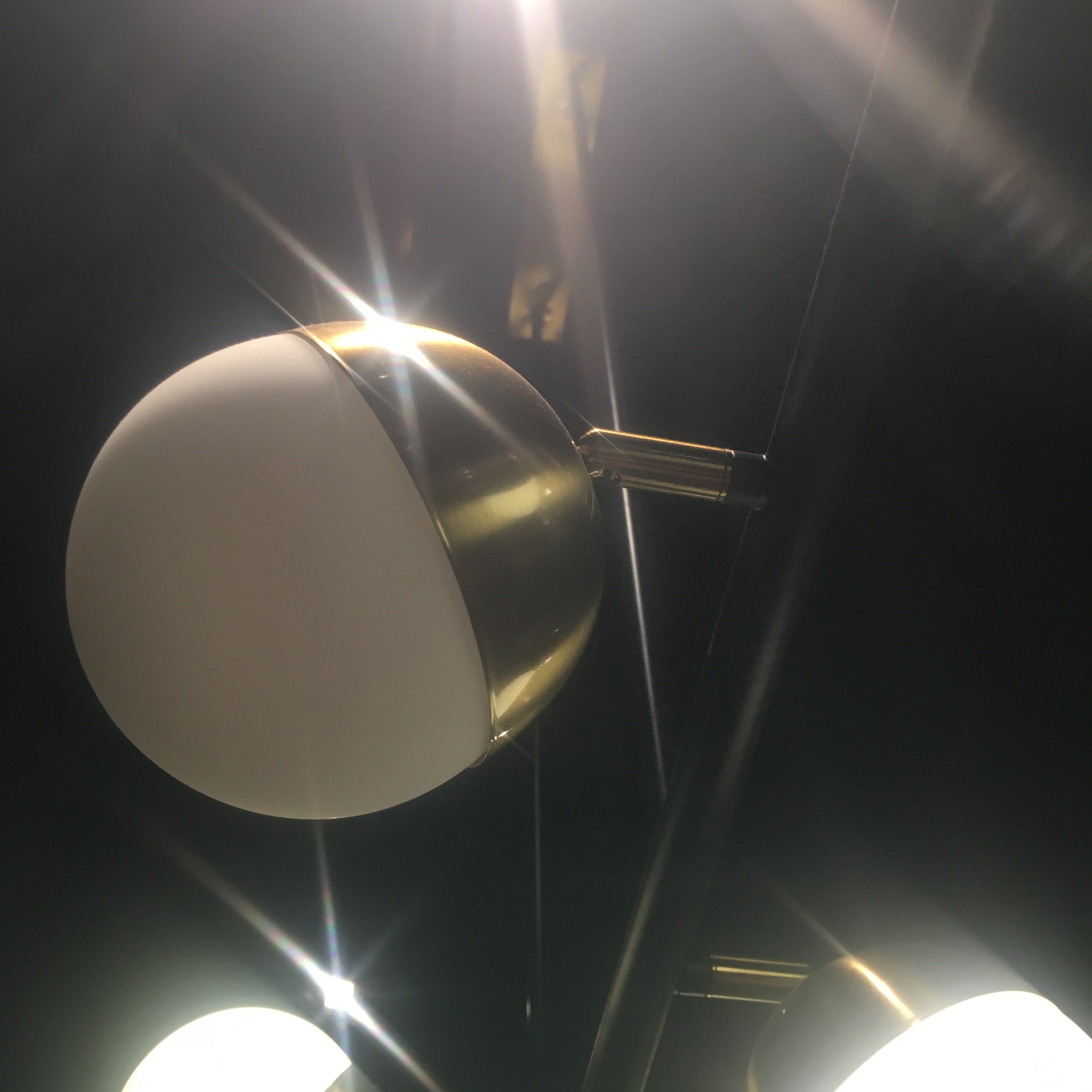 Display of Arvika 6 Heads Pendant Lamp by BEACON, showcasing modern chandelier with six hanging light fixtures.