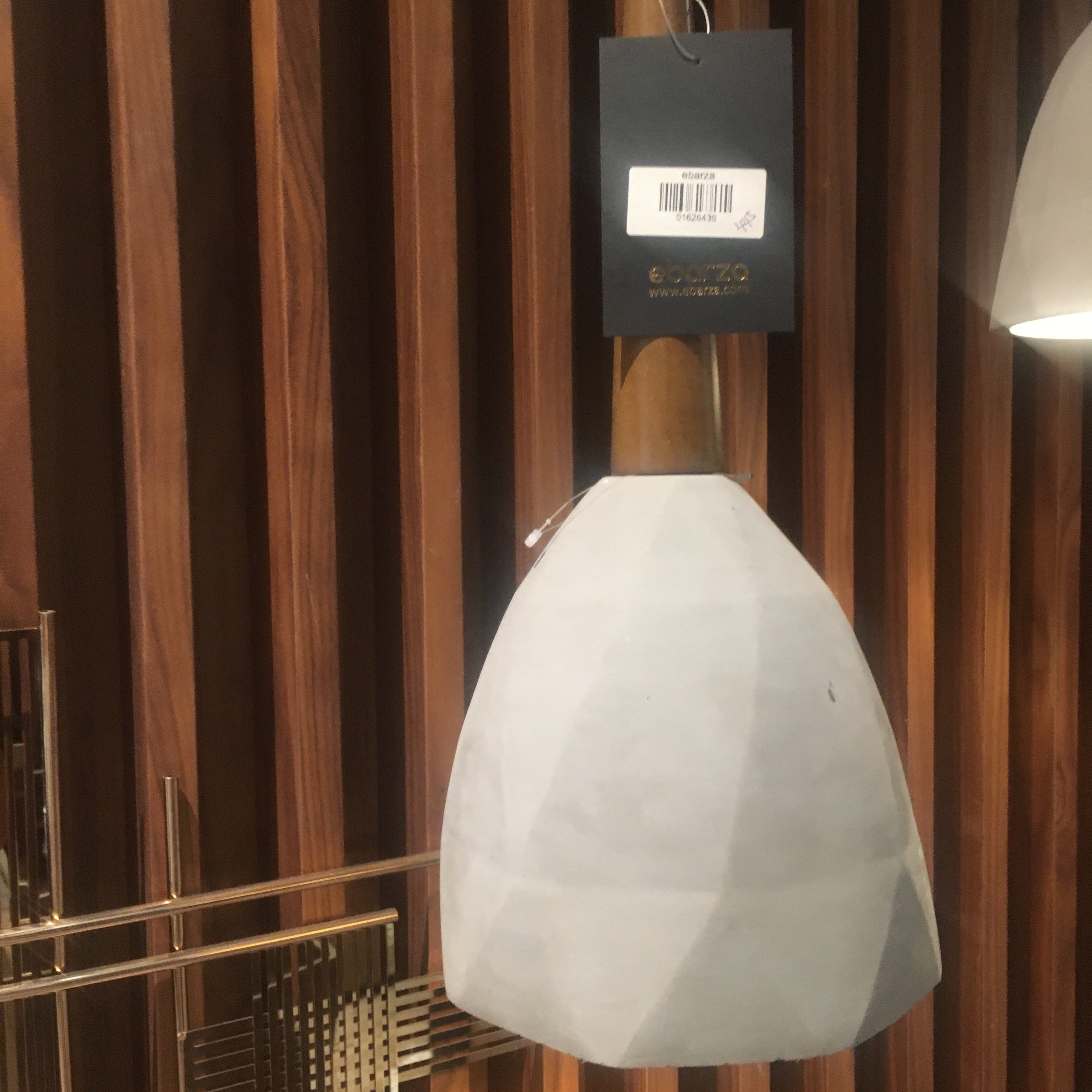 Large convex concrete and wood lamp display item by Beacon, featuring a modern, geometric design with a textured surface.