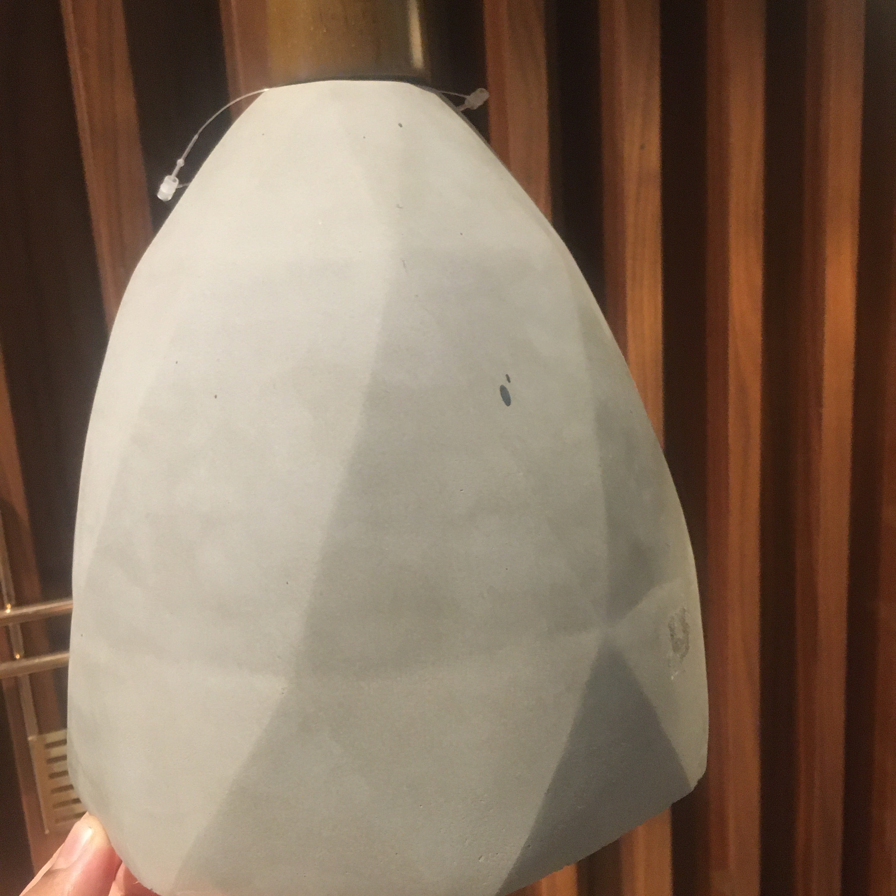 Large convex concrete and wood lamp display item by Beacon, featuring a modern design with mixed materials and sleek finish.