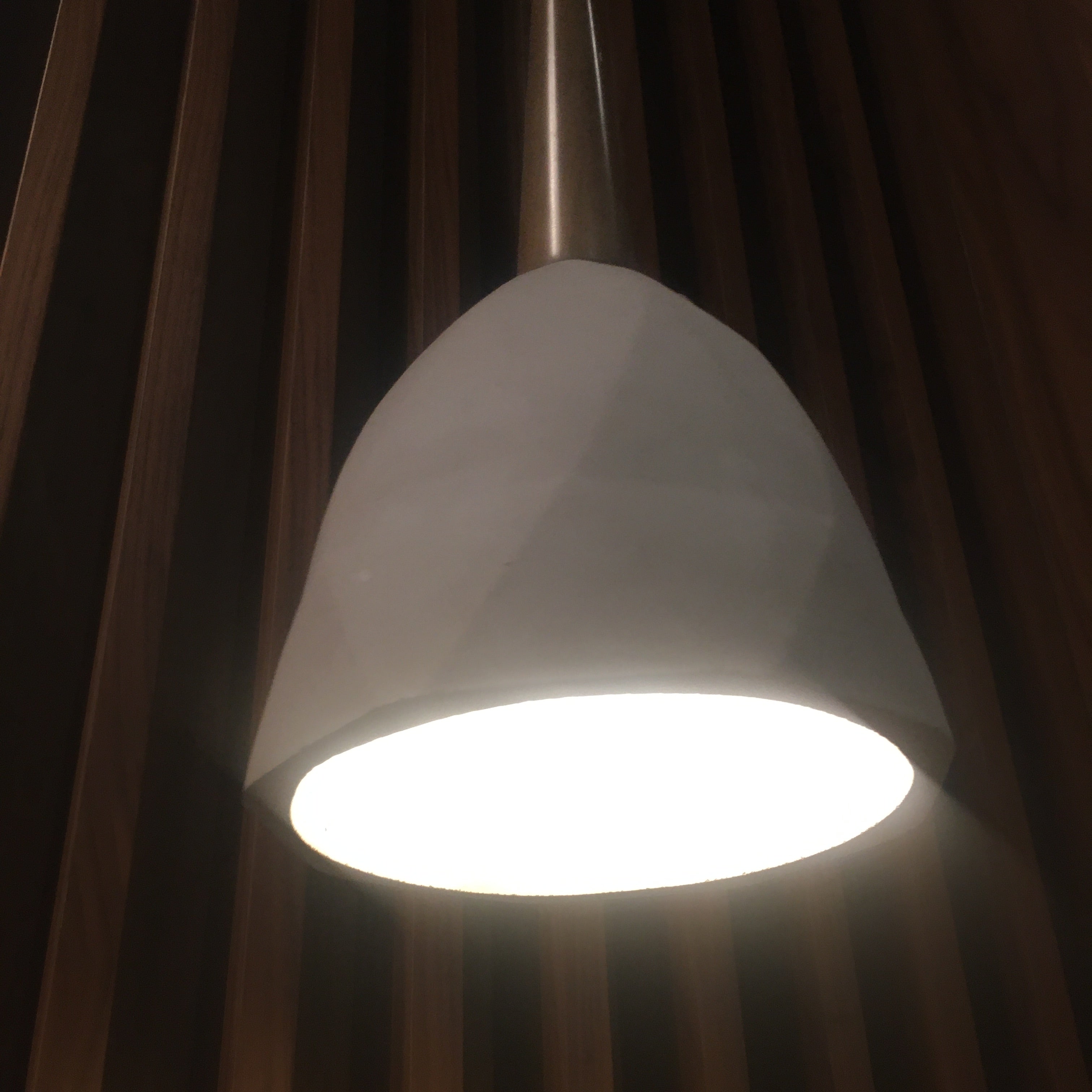 Large convex concrete and wood lamp display item by Beacon with a modern, textured design and a sleek wooden base.