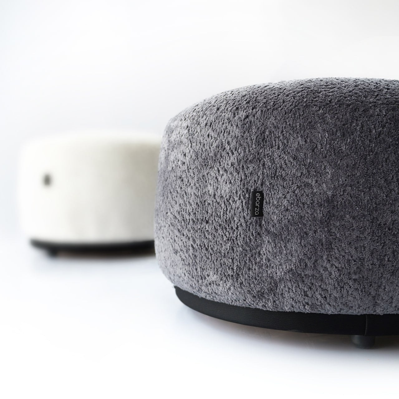 Gray Crown Pouf display item by SABRINO, featuring a plush, round design with a crown-inspired shape and soft fabric upholstery.