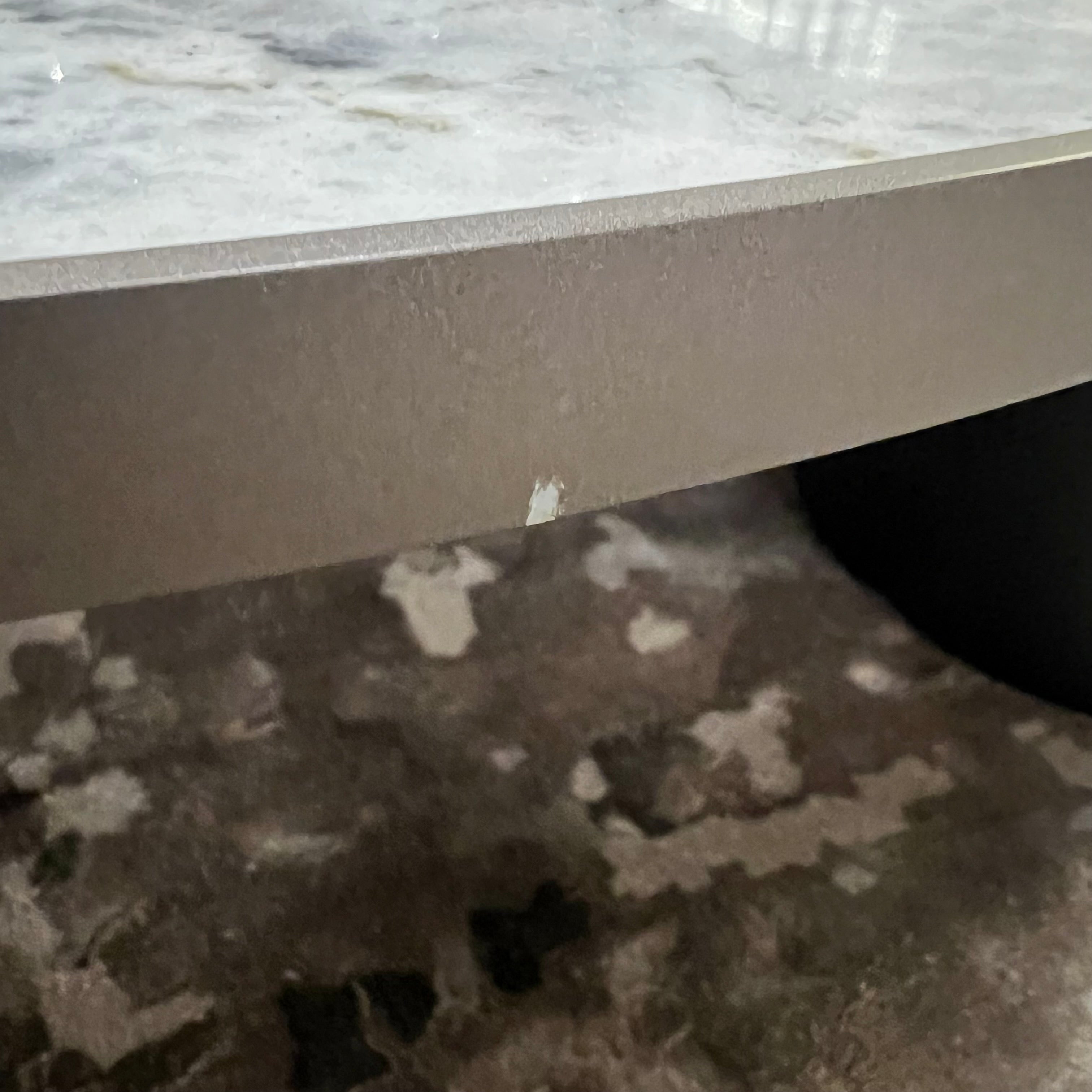 Display of a desert marble coffee table by Beacon, showcasing a sleek, modern design with a marble top and sturdy base.