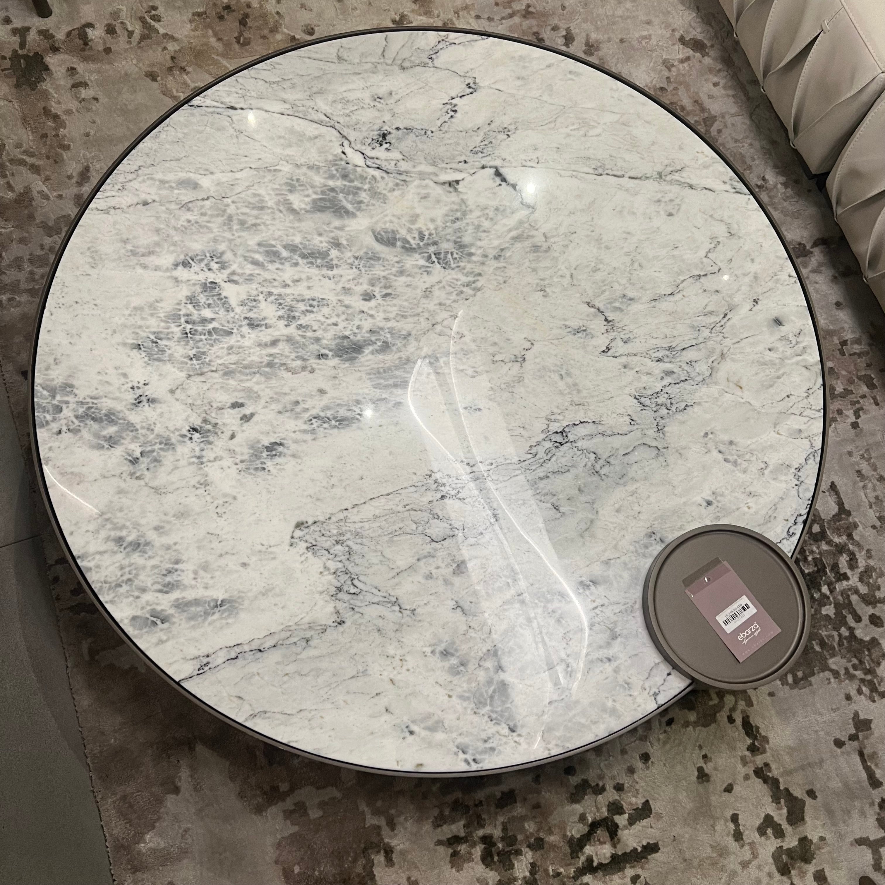 Display item of a desert marble coffee table by Beacon, showcasing a sleek, modern design with a marble top and sturdy base.