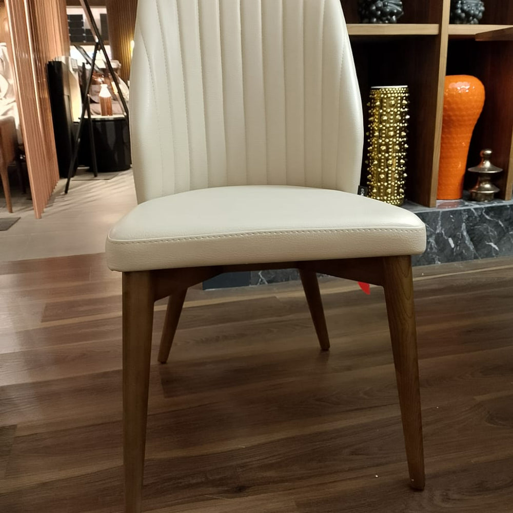 Display of the Eco Nirvana Diva solid ash wood chair by OZZO, showcasing its elegant design and natural wood finish.