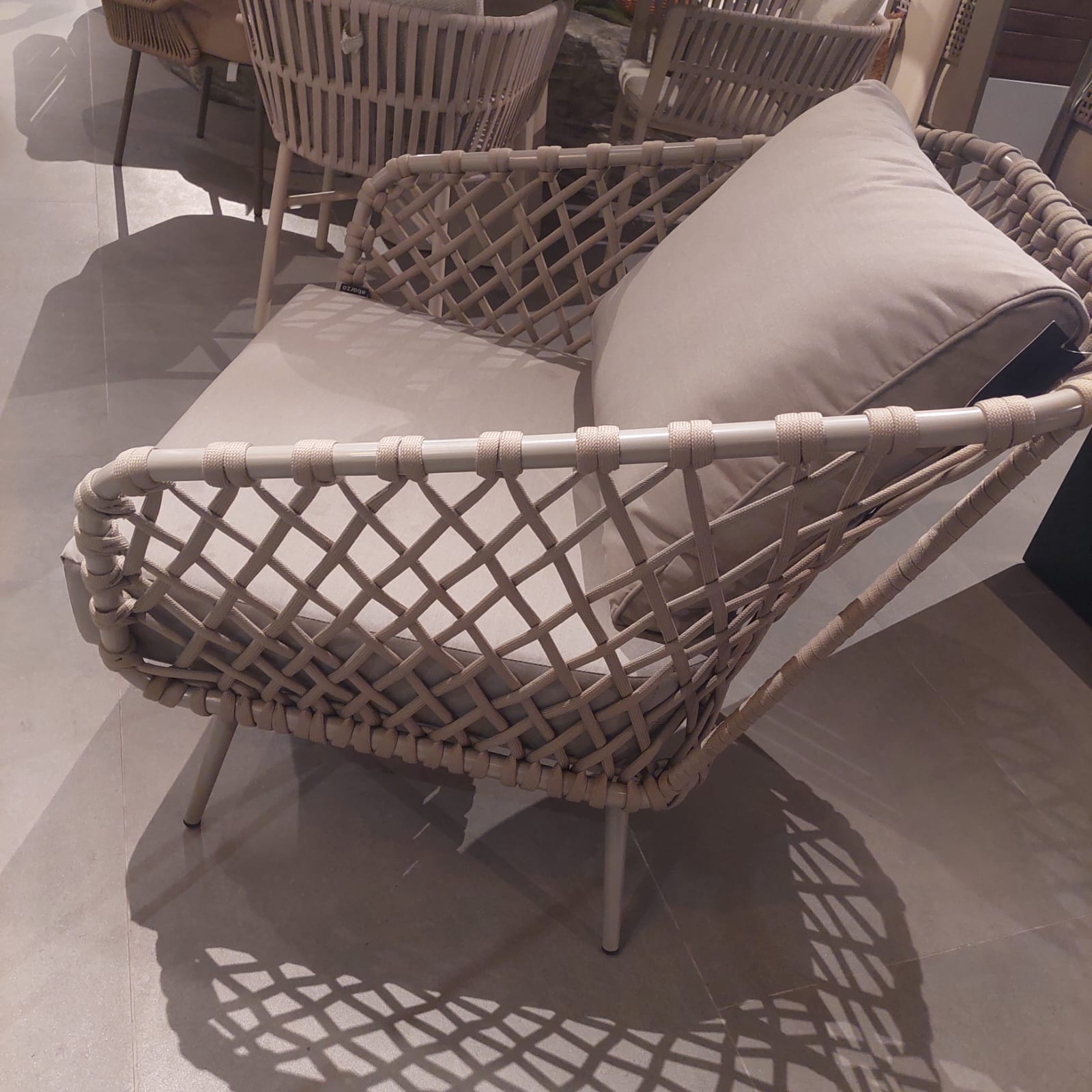 Display of the Evolve Outdoor Armchair by Beacon, showing its sleek design and durable outdoor seating features.
