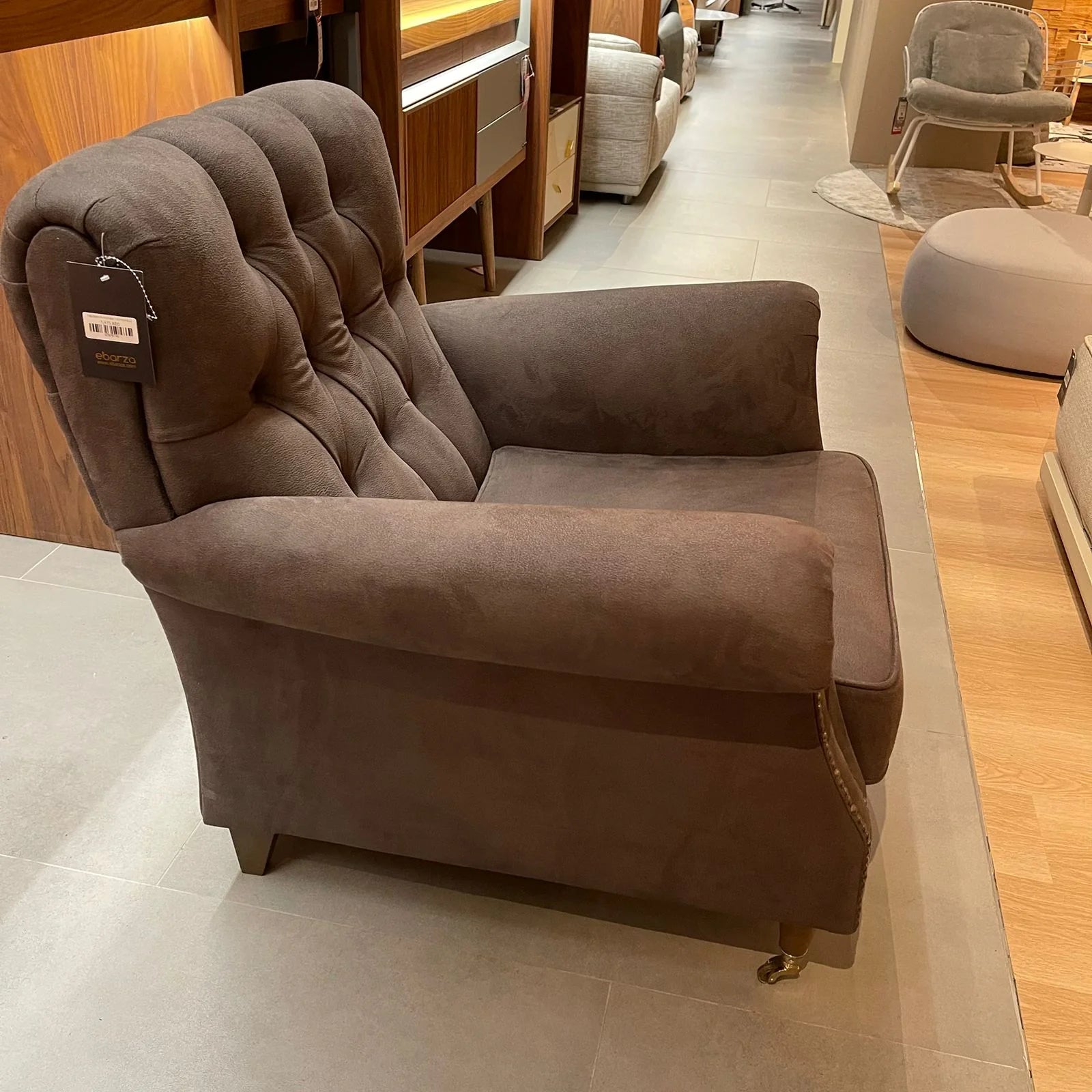 Display of a modern fashion armchair by NDESIGN, model Fashion112, with a sleek design and neutral fabric upholstery.