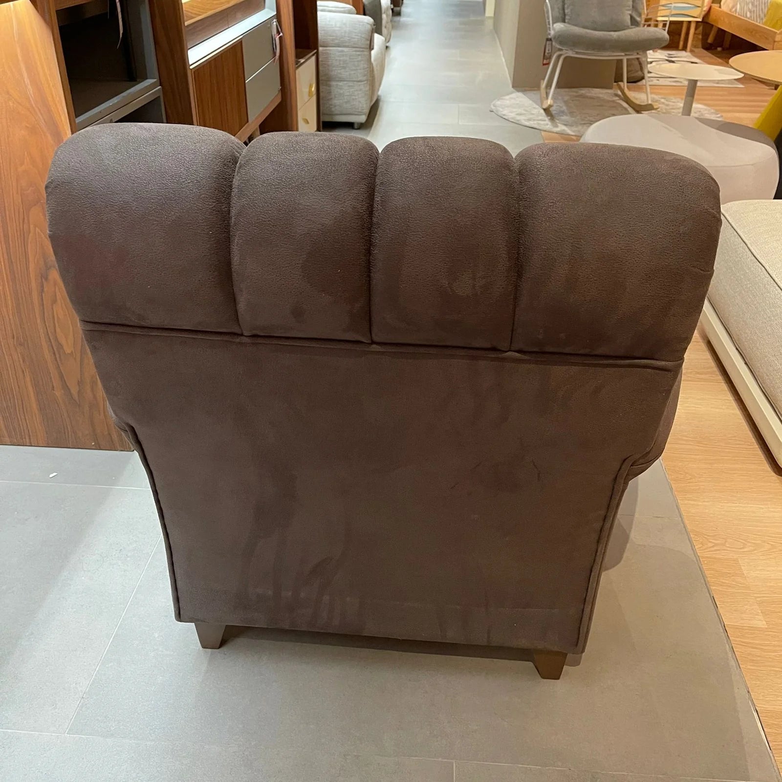 Fashion112 YAS armchair display item by NDESIGN, featuring modern design with plush upholstery and sleek wooden legs.