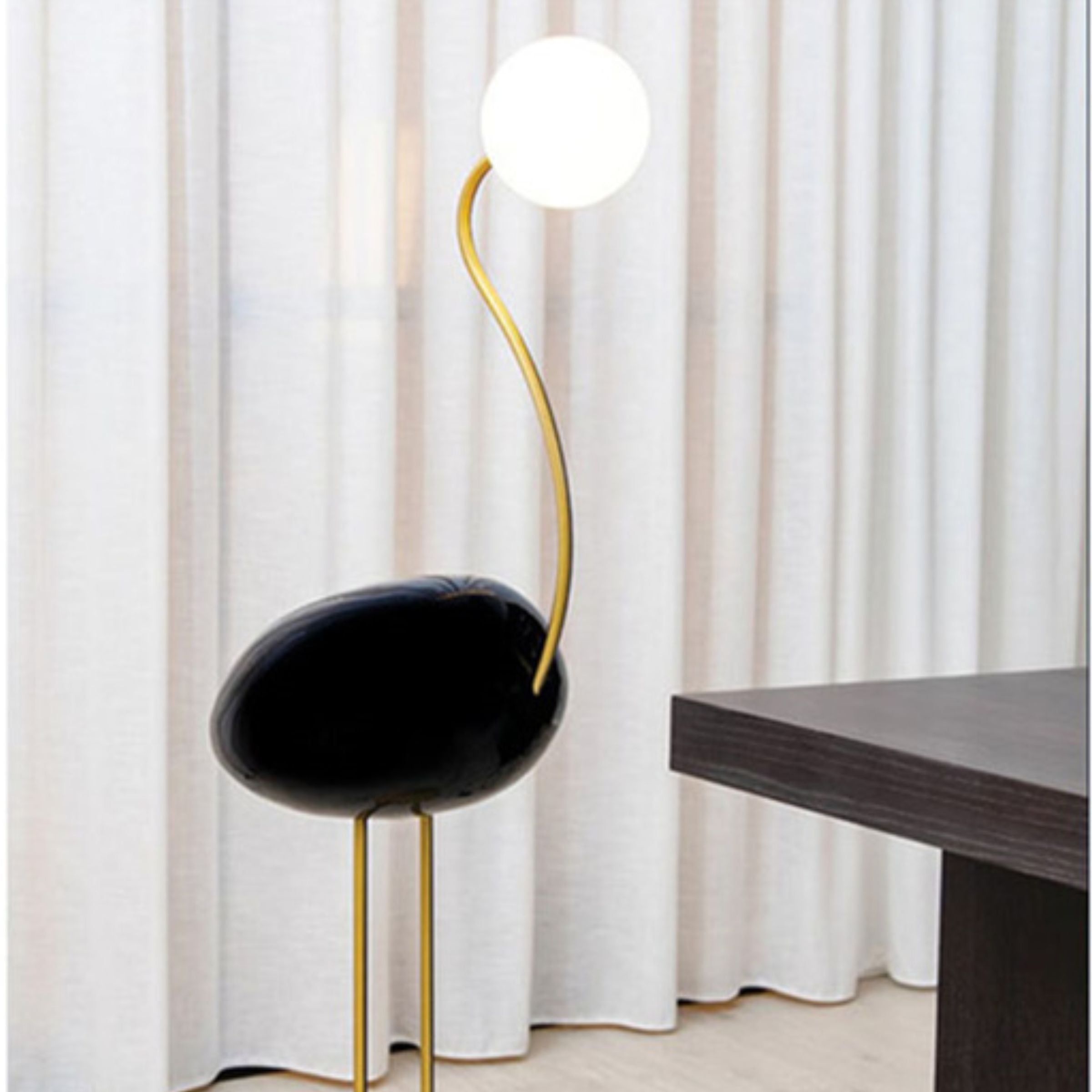 Black Flamingo Floor Lamp by BEACON, featuring a sleek design and standing tall as a stylish lighting fixture.