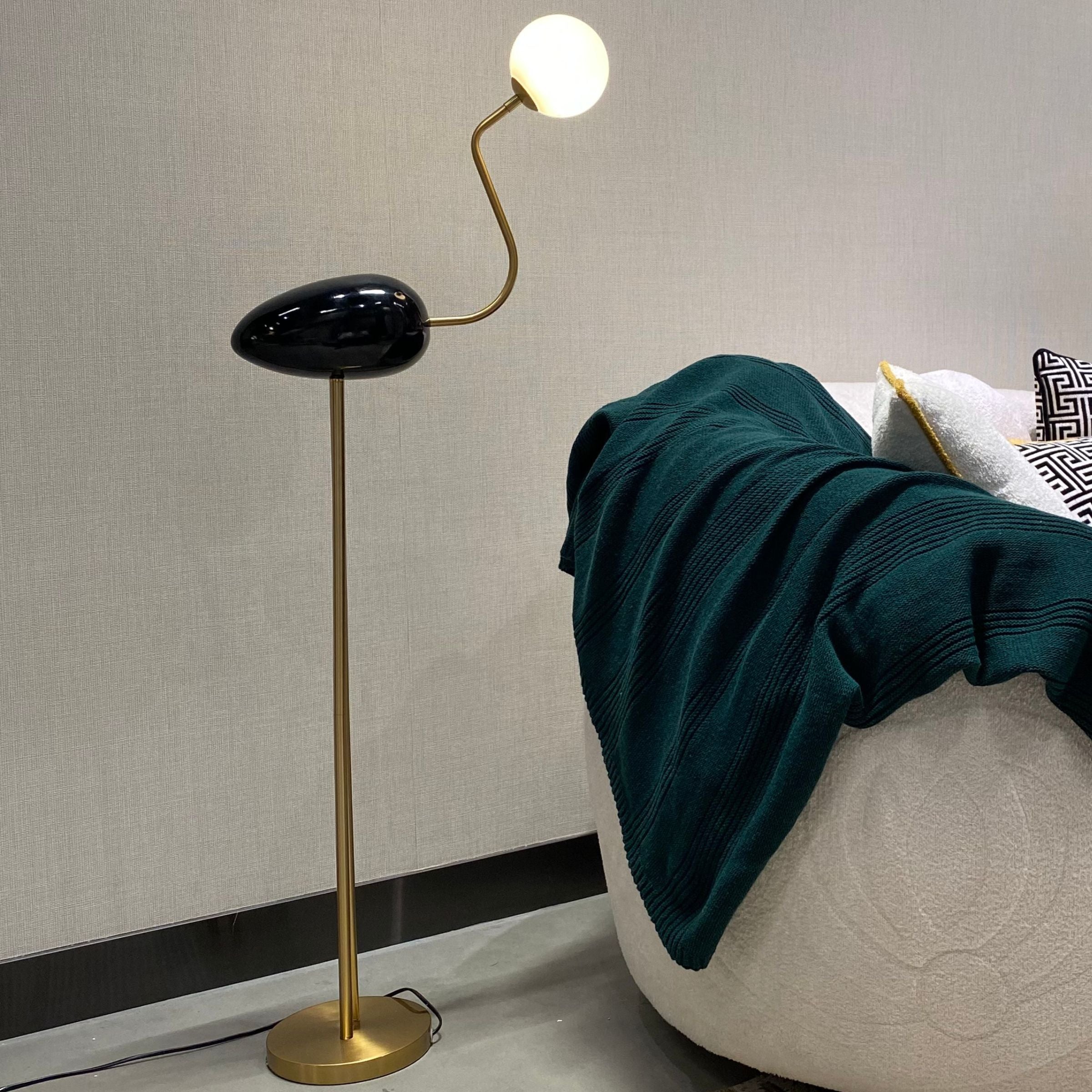 Black Flamingo Floor Lamp by BEACON, showcasing a modern flamingo-shaped design with a sleek black finish.