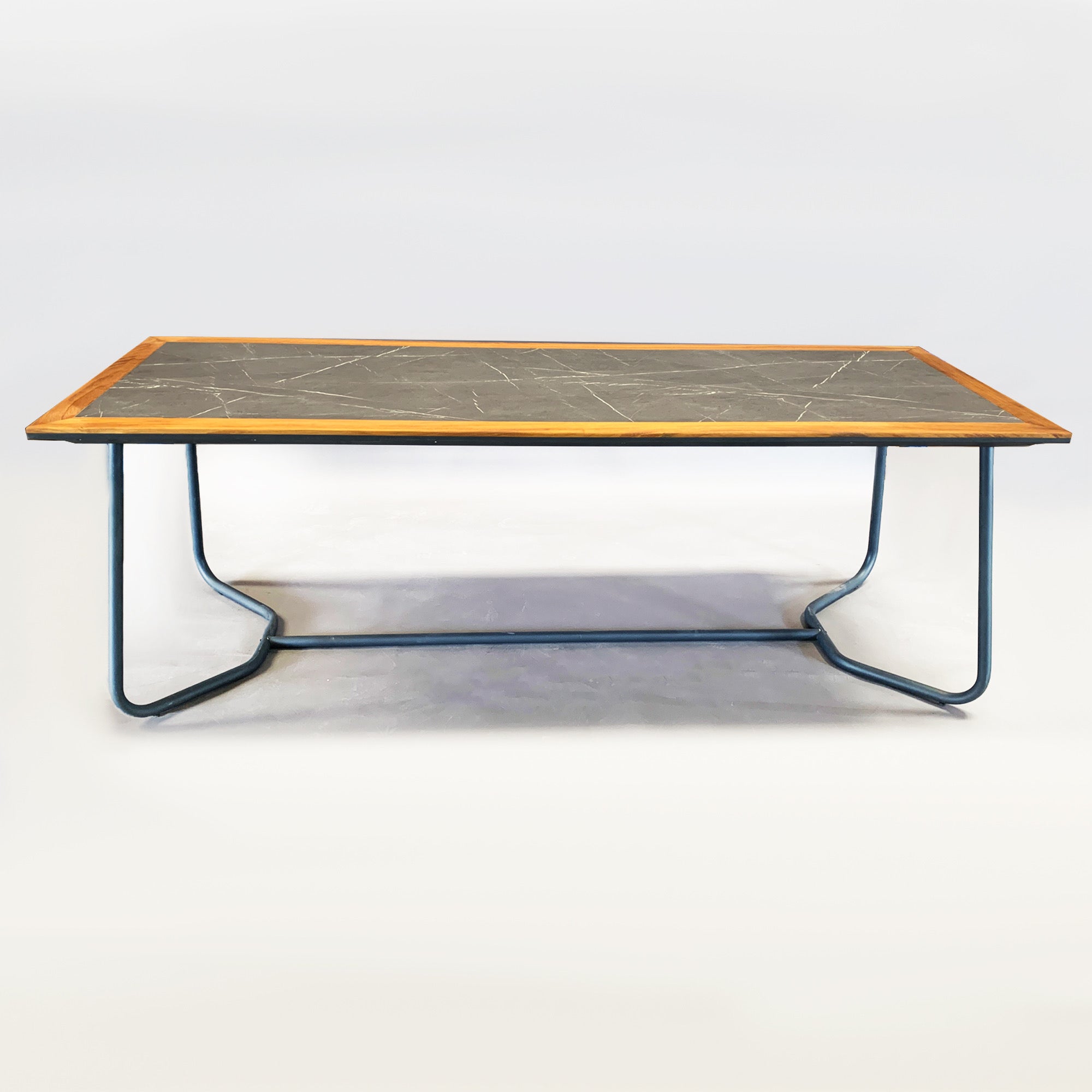 Display of SANCREA Mythra outdoor table featuring solid teak wood and aluminum construction for stylish outdoor dining.