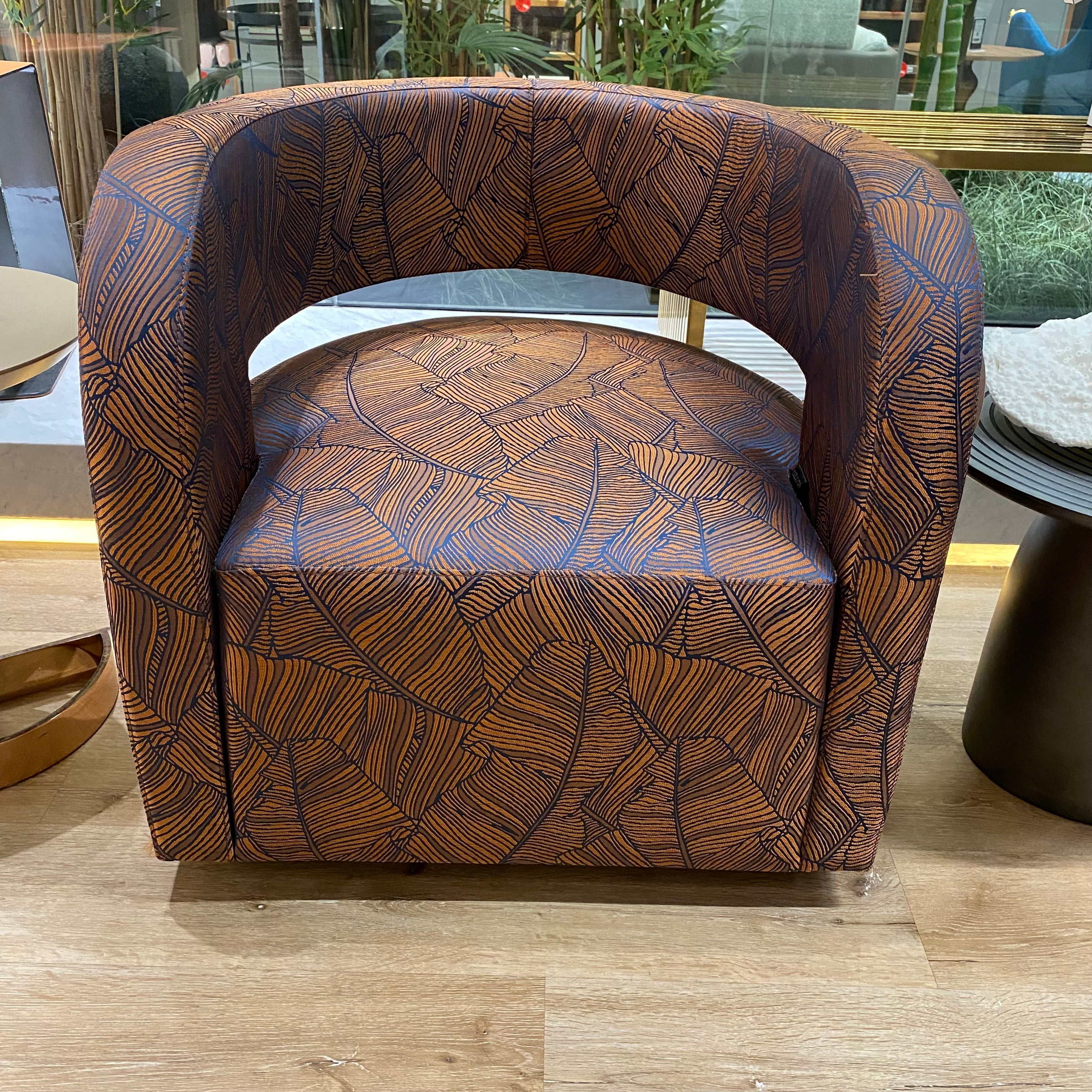 Display of Gilles Lounge Chair by LODA Furniture, showcasing its modern design with plush upholstery and sleek wooden legs.