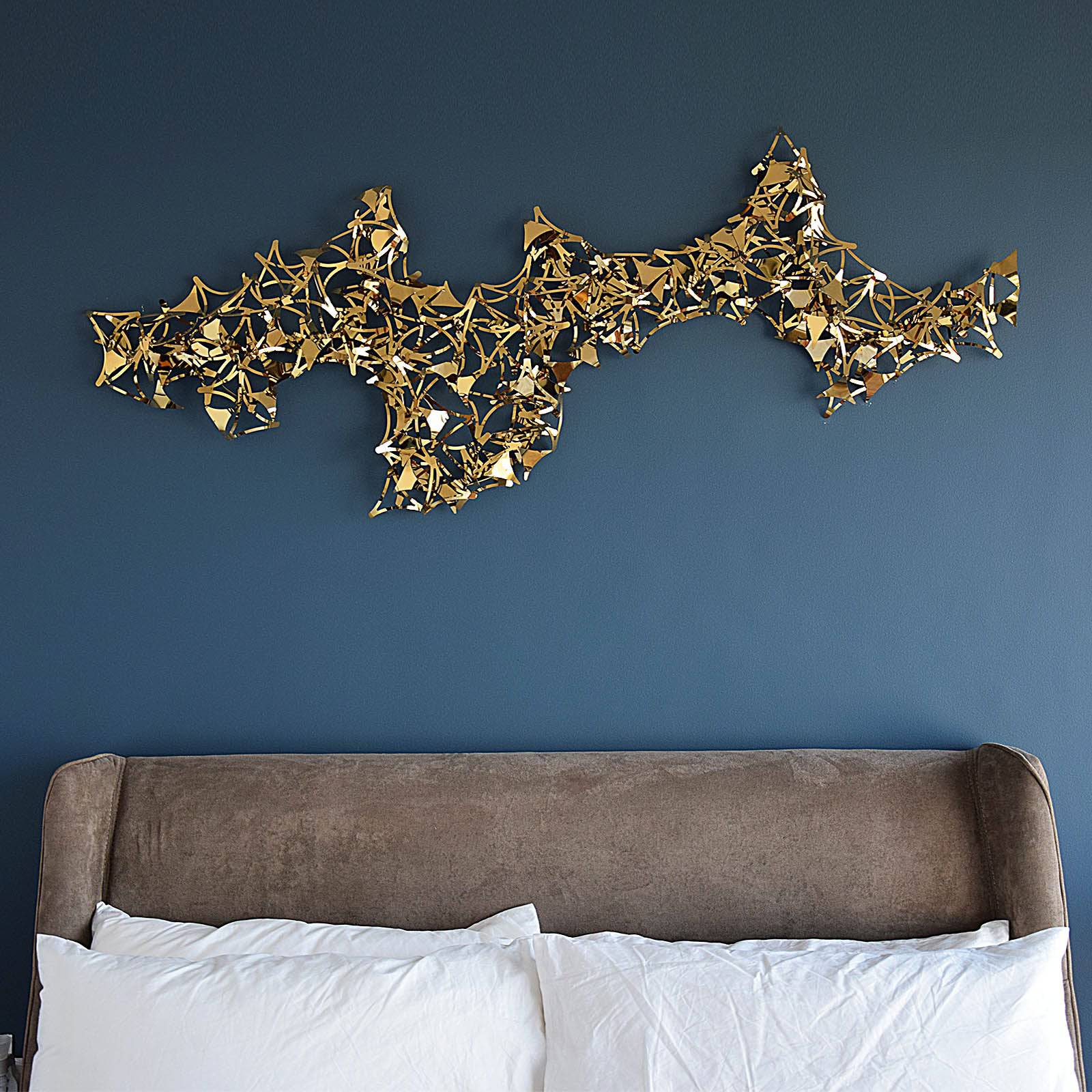 Golden stars handcrafted stainless steel artwork display item by Beacon, showcasing intricate star designs on a sleek background.