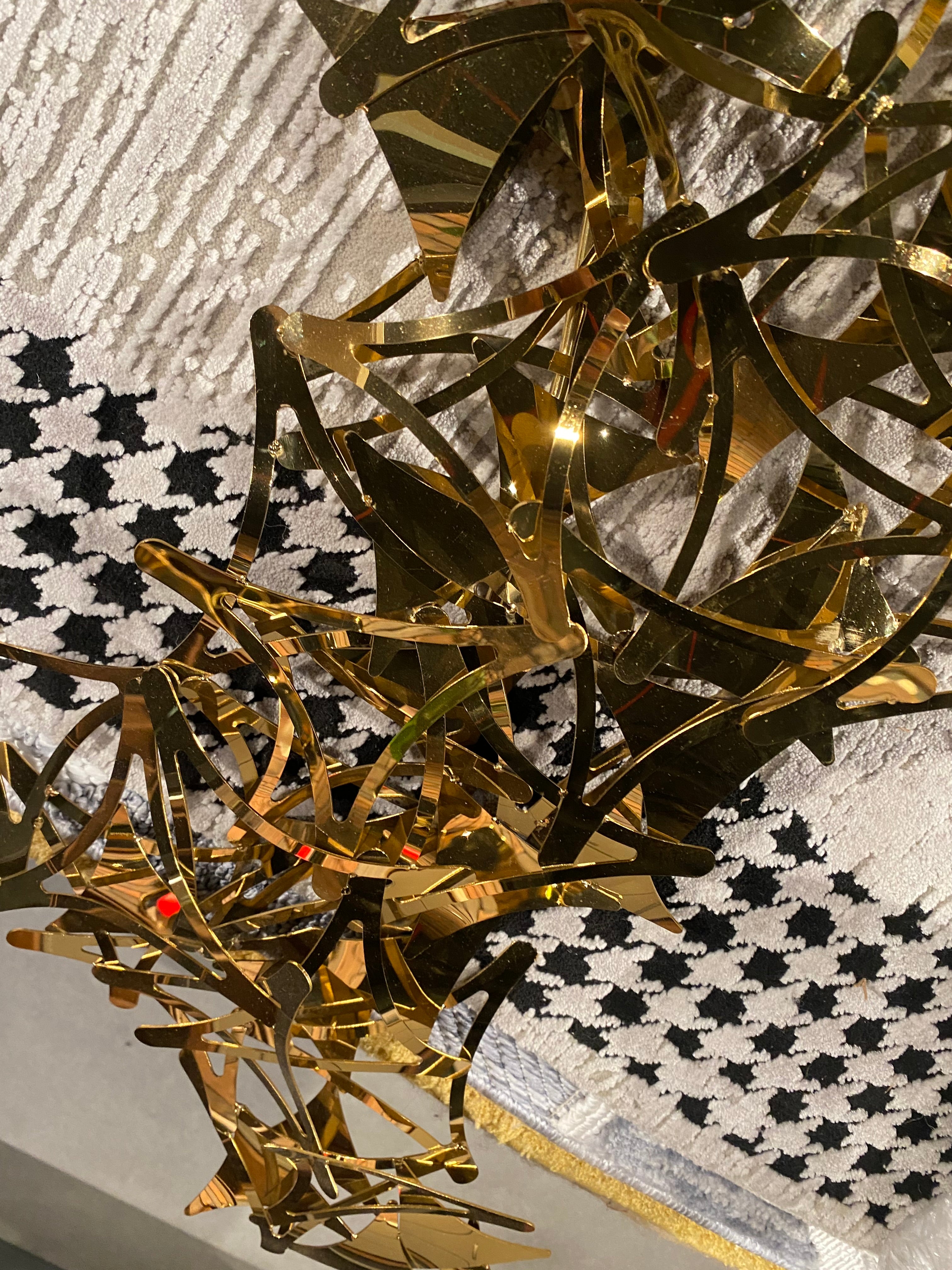 Golden stars handcrafted stainless steel artwork display item by BEACON, featuring intricate metallic star design.