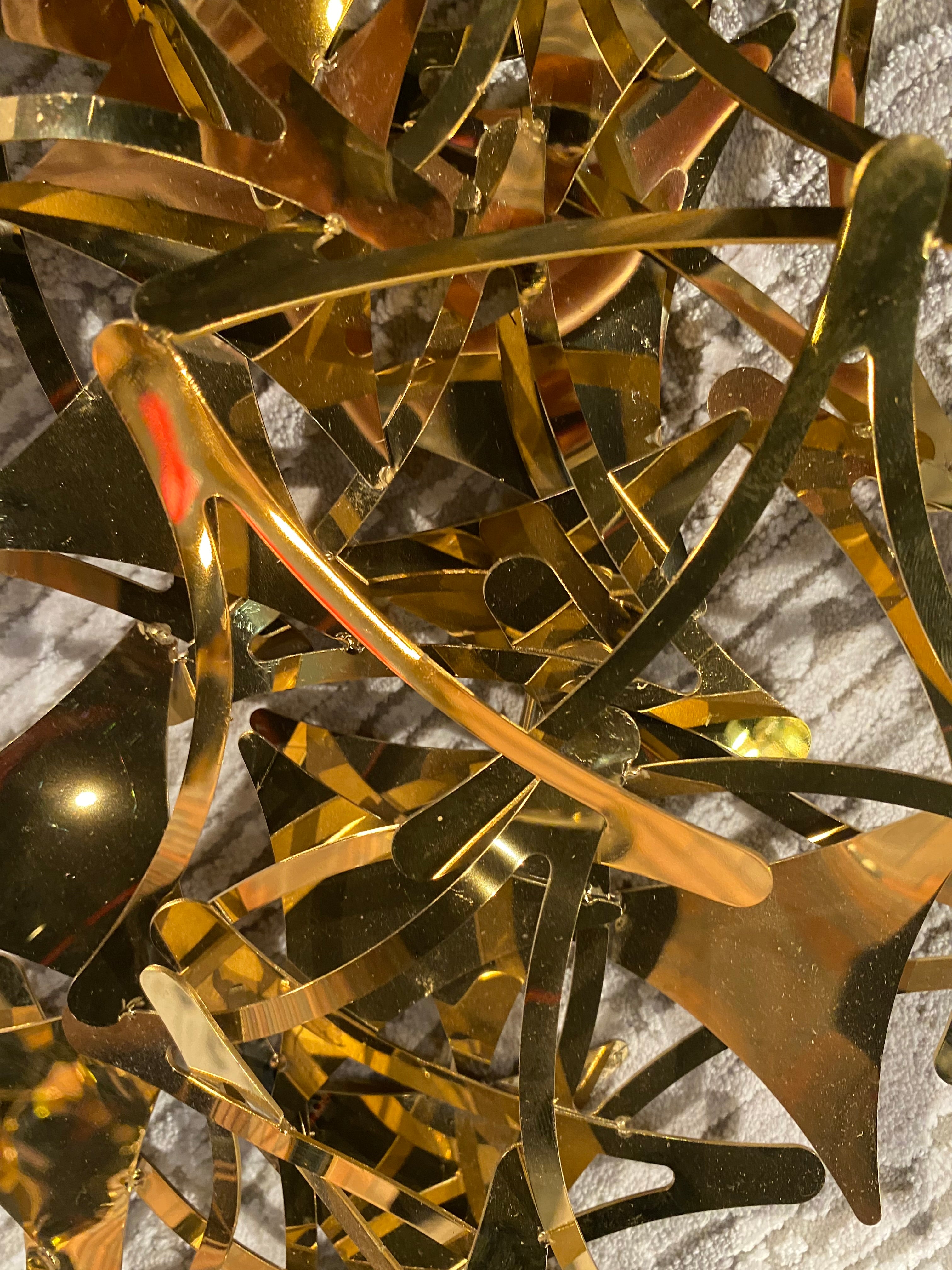 Golden stars handcrafted stainless steel artwork display item by BEACON, featuring intricate metal craftsmanship.