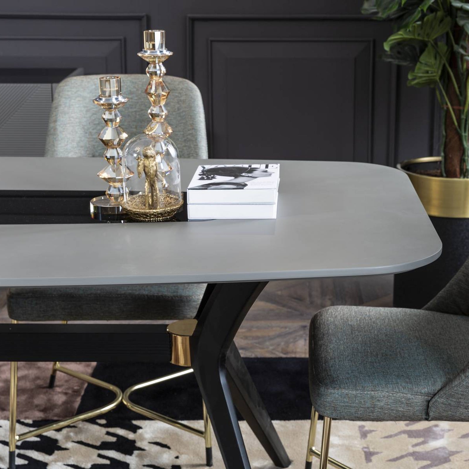 Grey dining table display item from YOL LIVING, with a modern design, showcasing a sleek, sturdy table surface.
