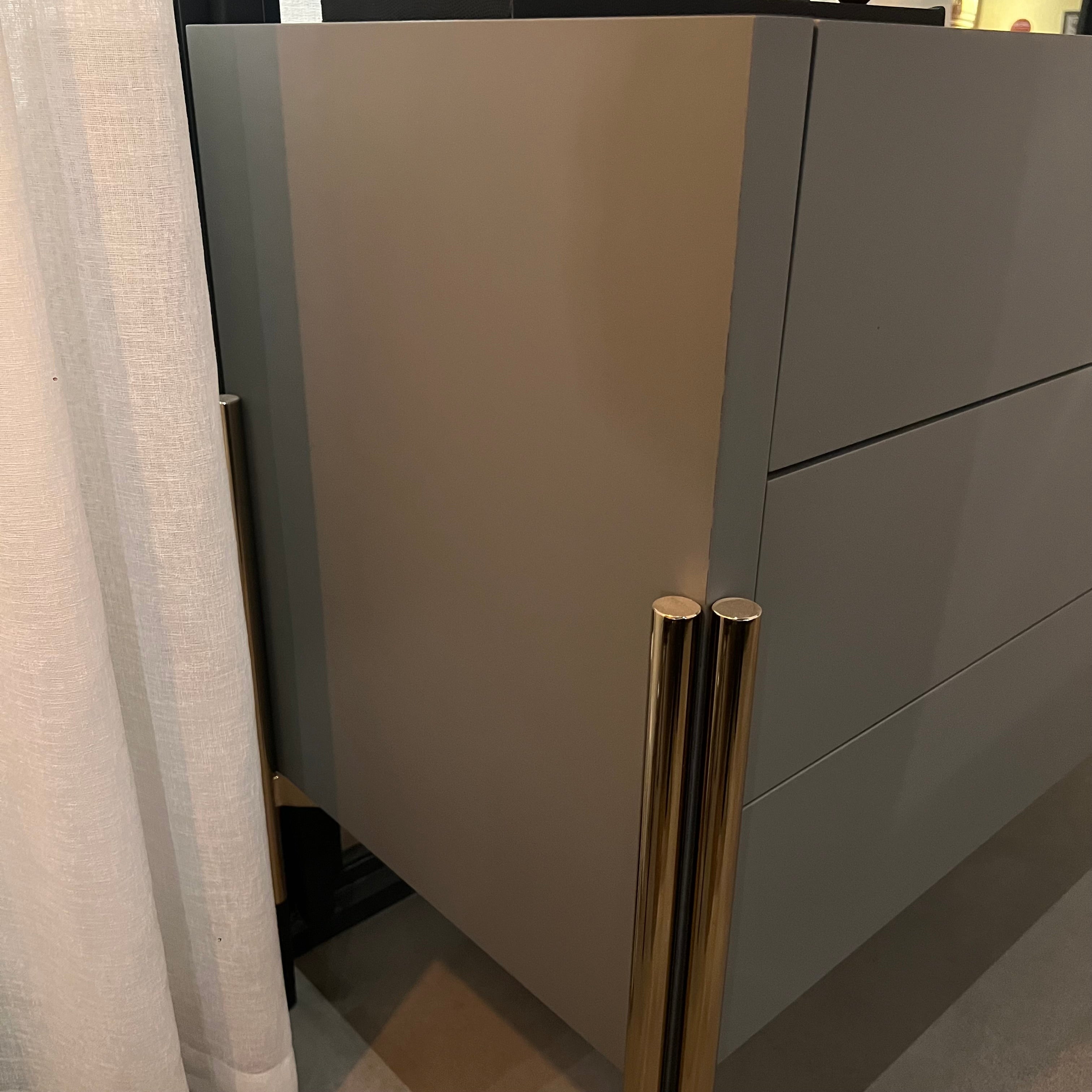 Grey dresser and mirror display item by YOL LIVING, featuring a modern dresser with a matching mirror for stylish bedroom storage.