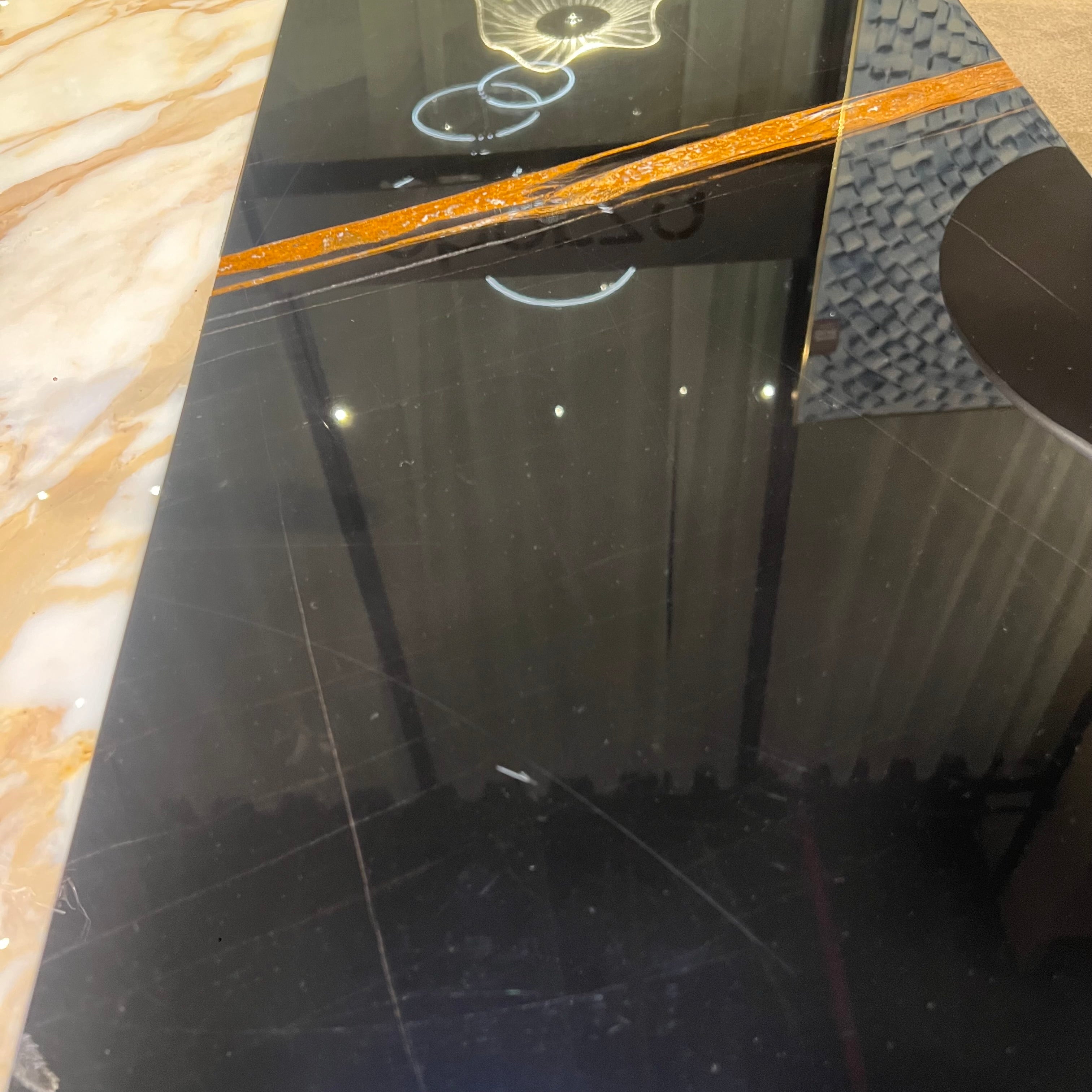 Display image of Lauren coffee table by BEACON with black and gold finish, featuring a modern design with sleek lines.
