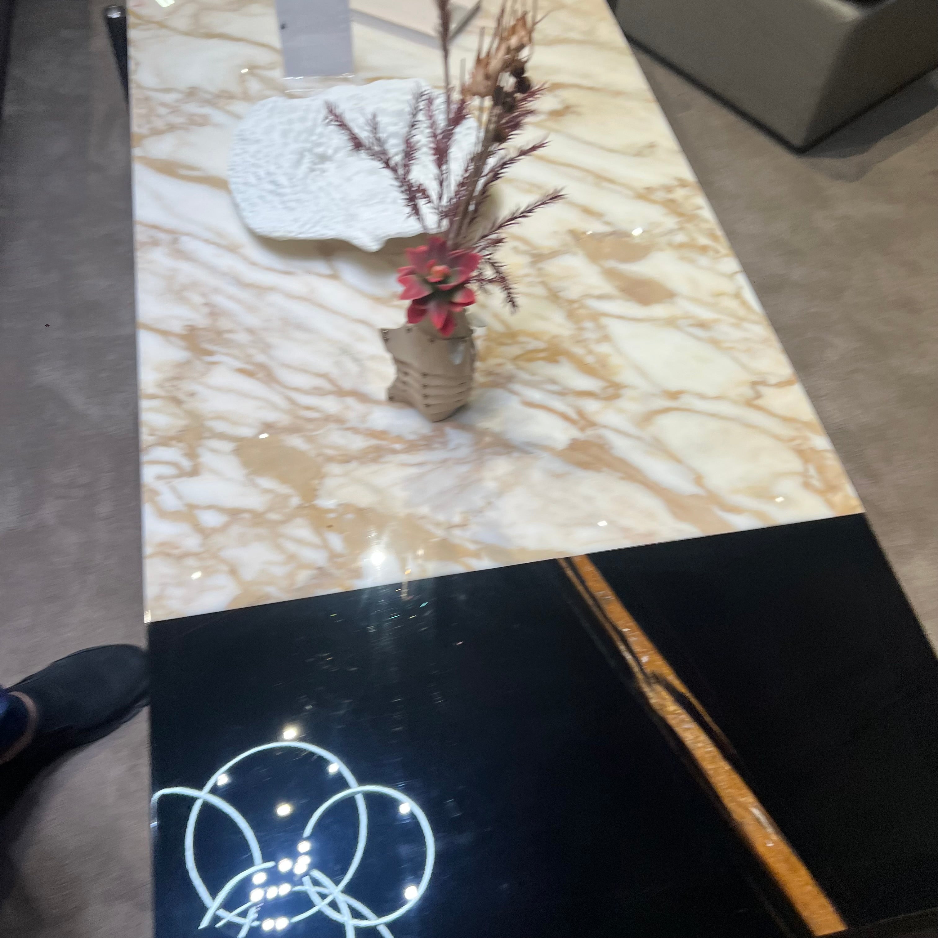Black and gold Lauren coffee table display item with sleek design and modern style from BEACON.