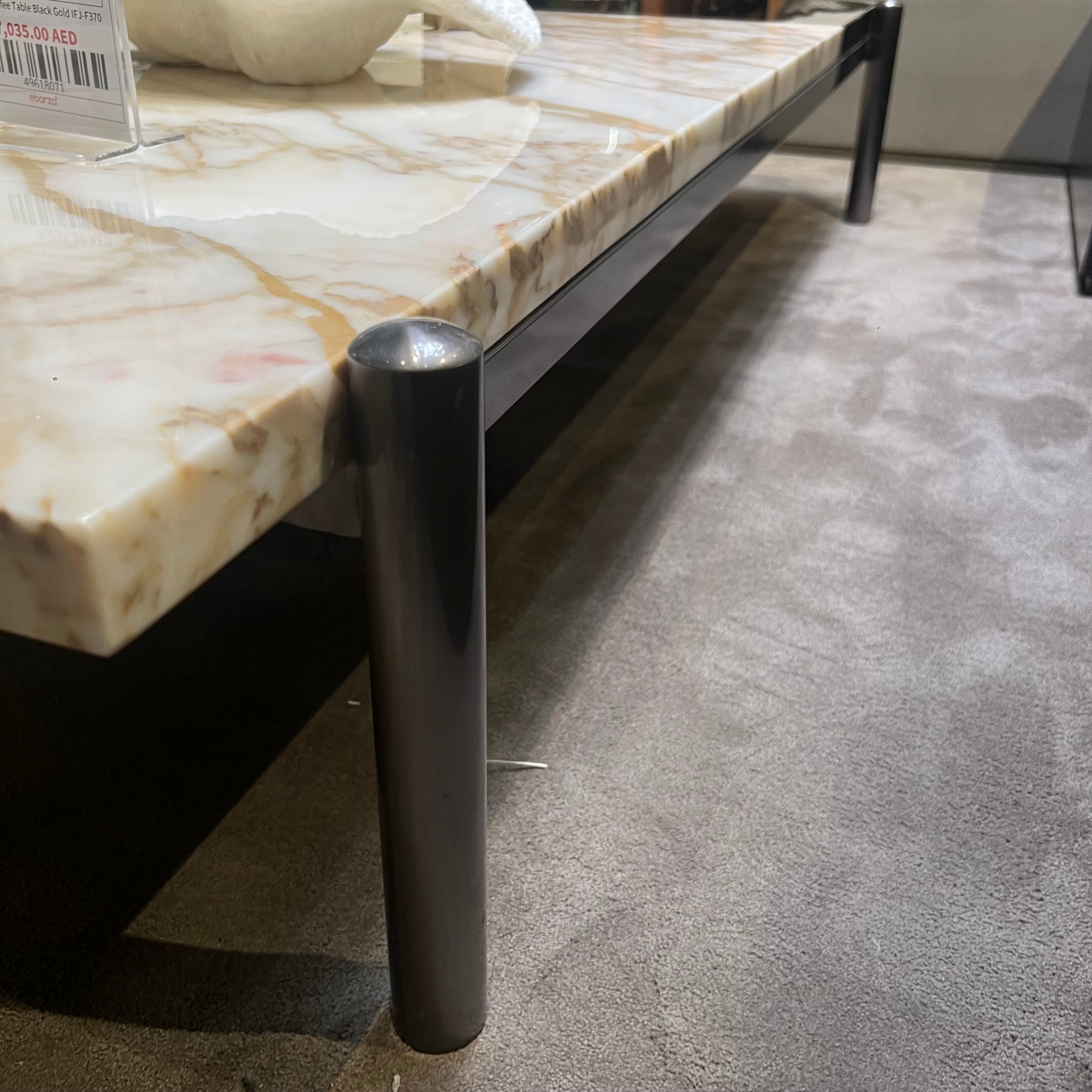 Black and gold Lauren coffee table by Beacon, featuring a sleek modern design with a sturdy display stand.