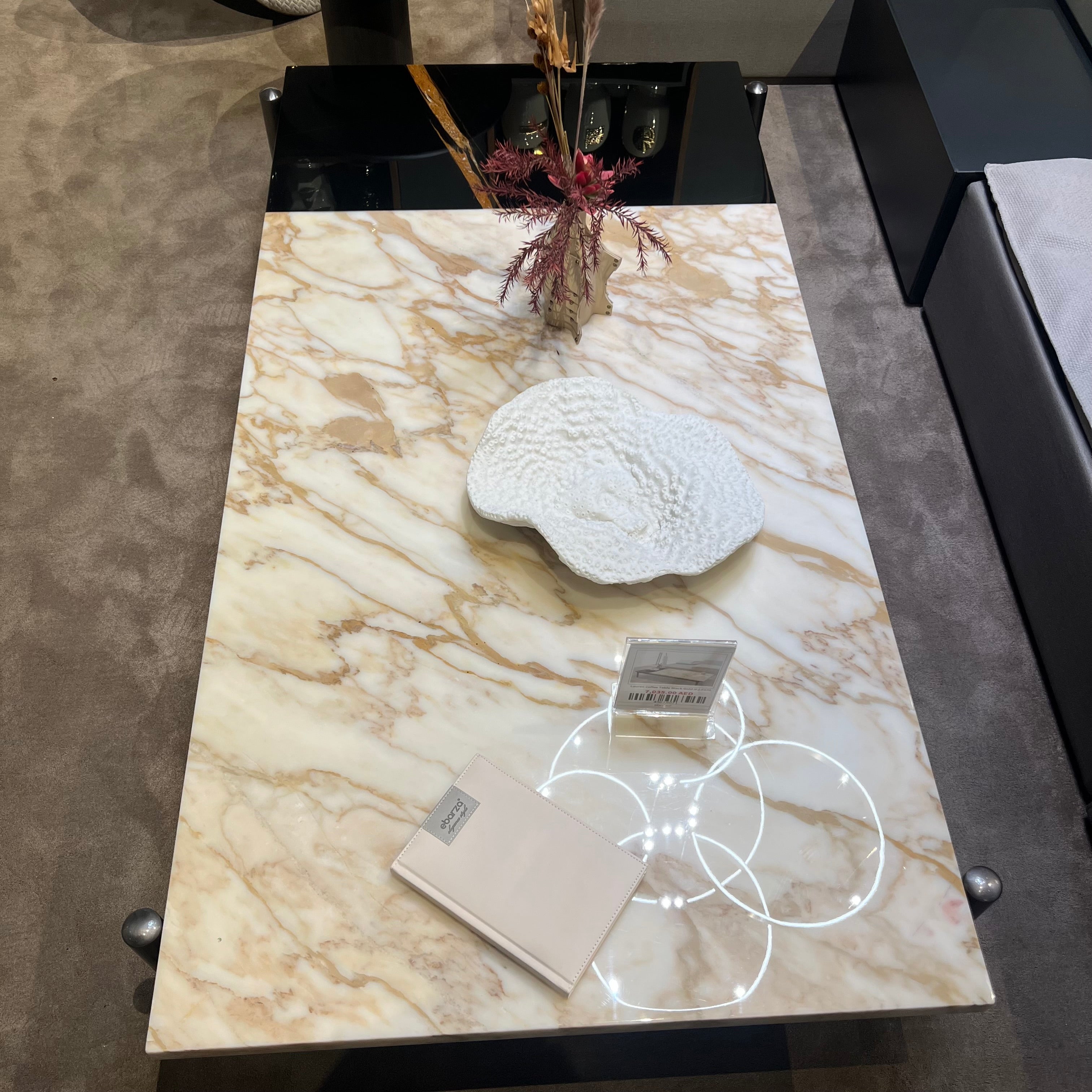 Black and gold Lauren coffee table by BEACON with sleek design, featuring a modern display style and geometric accents.