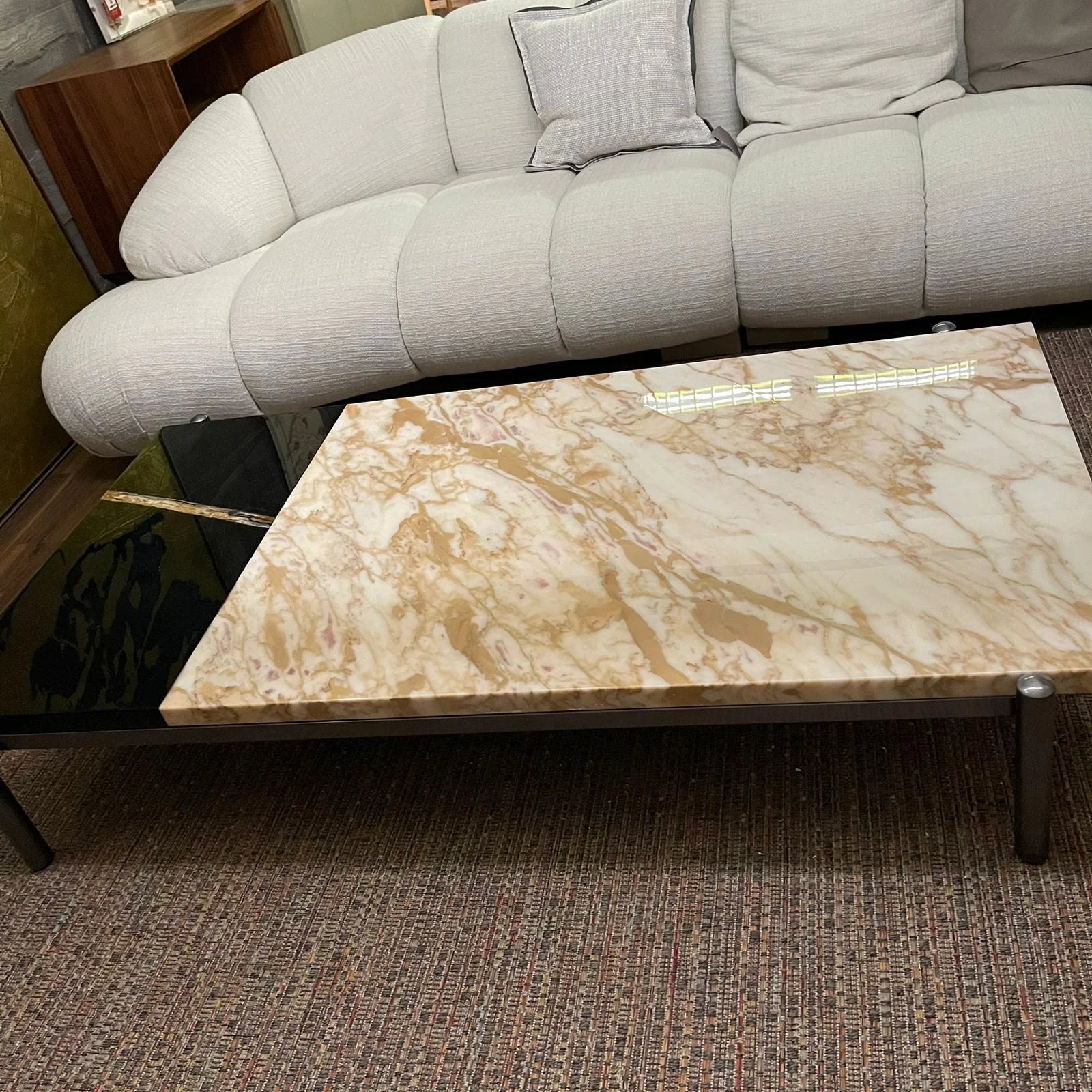 Display of the Lauren coffee table by Beacon in black with gold accents, showcasing its modern design and sleek finish.