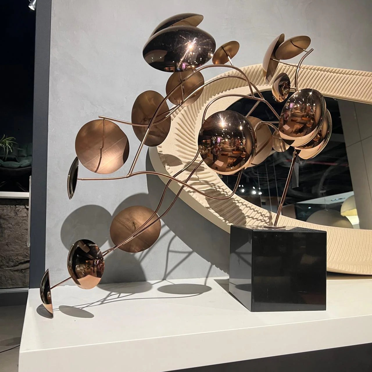 Handcrafted stainless steel table artwork featuring a life branch design, displayed on a sleek surface, by BEACON.