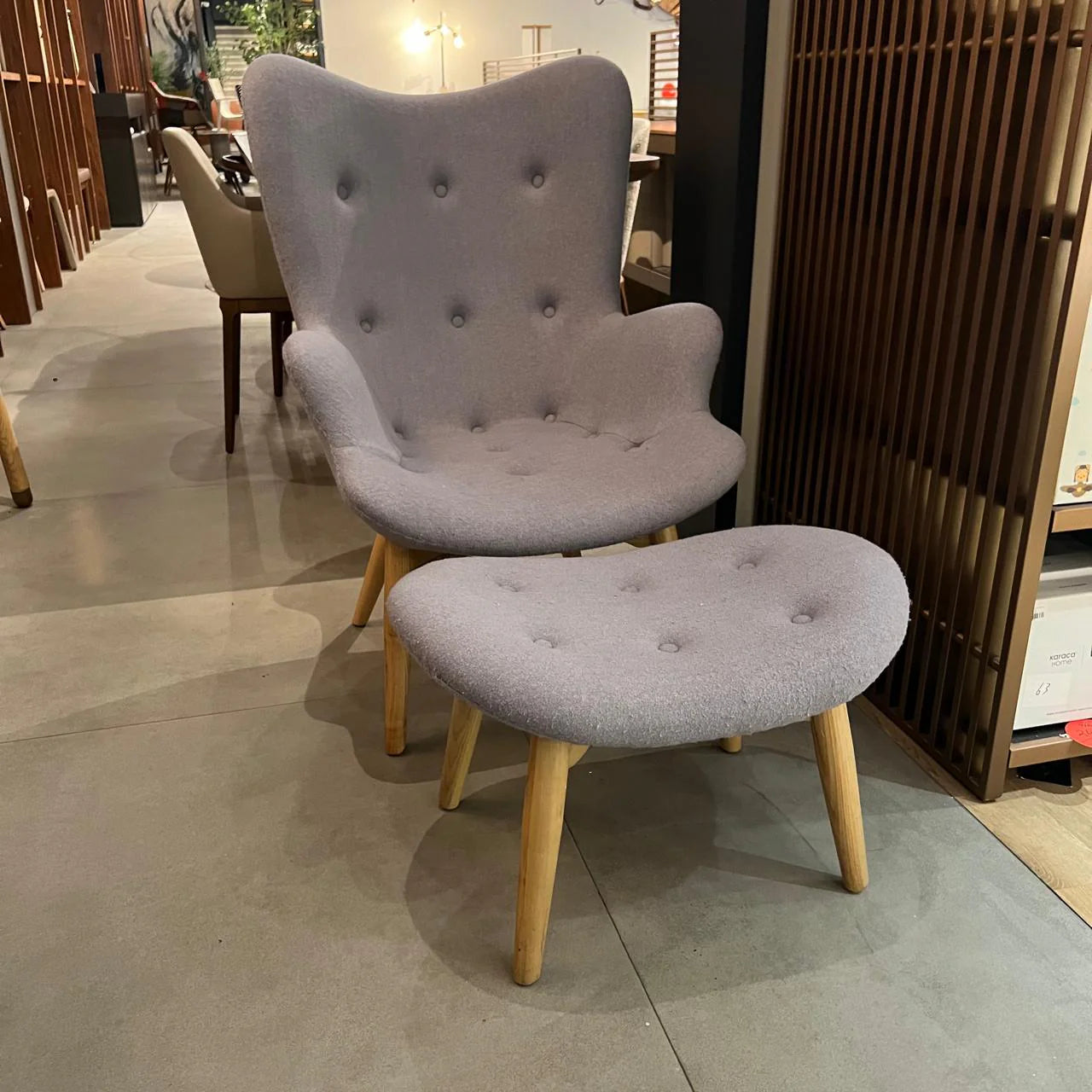Display of a Beacon Nakheel lounge chair with matching ottoman, modern design, in a neutral fabric finish.