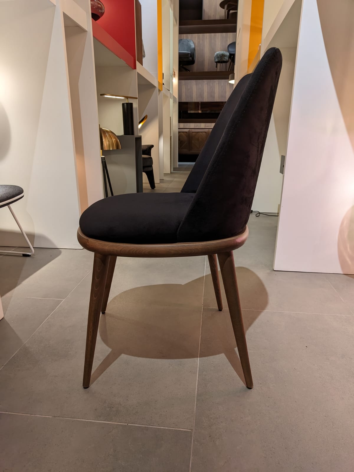 Display of Luna Dining Chair by YOL LIVING, showcasing its modern design and wooden frame in a stylish dining setup.