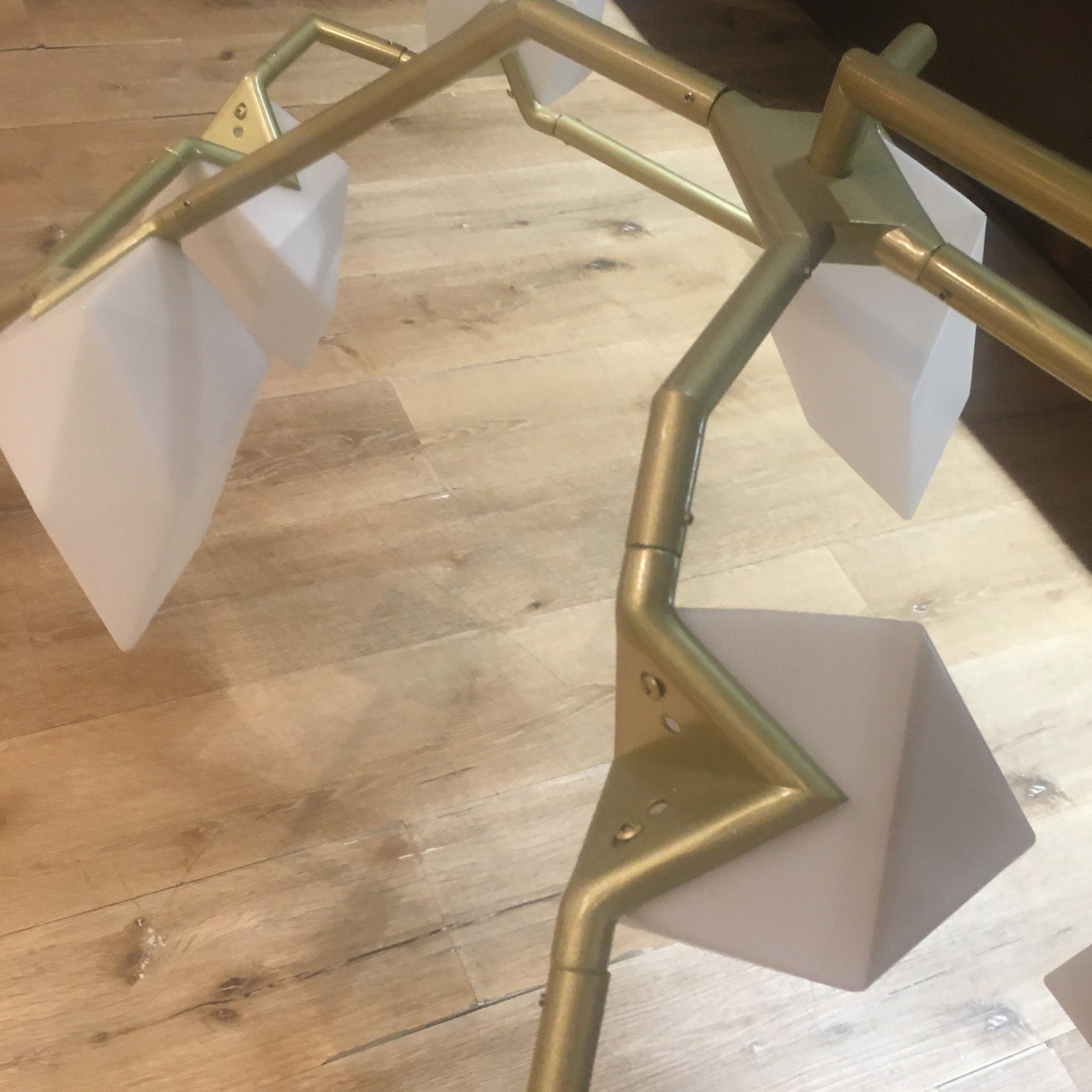 Display of the Masko 12 Heads Chandelier by BEACON, showcasing its elegant multi-head crystal design on a display stand.