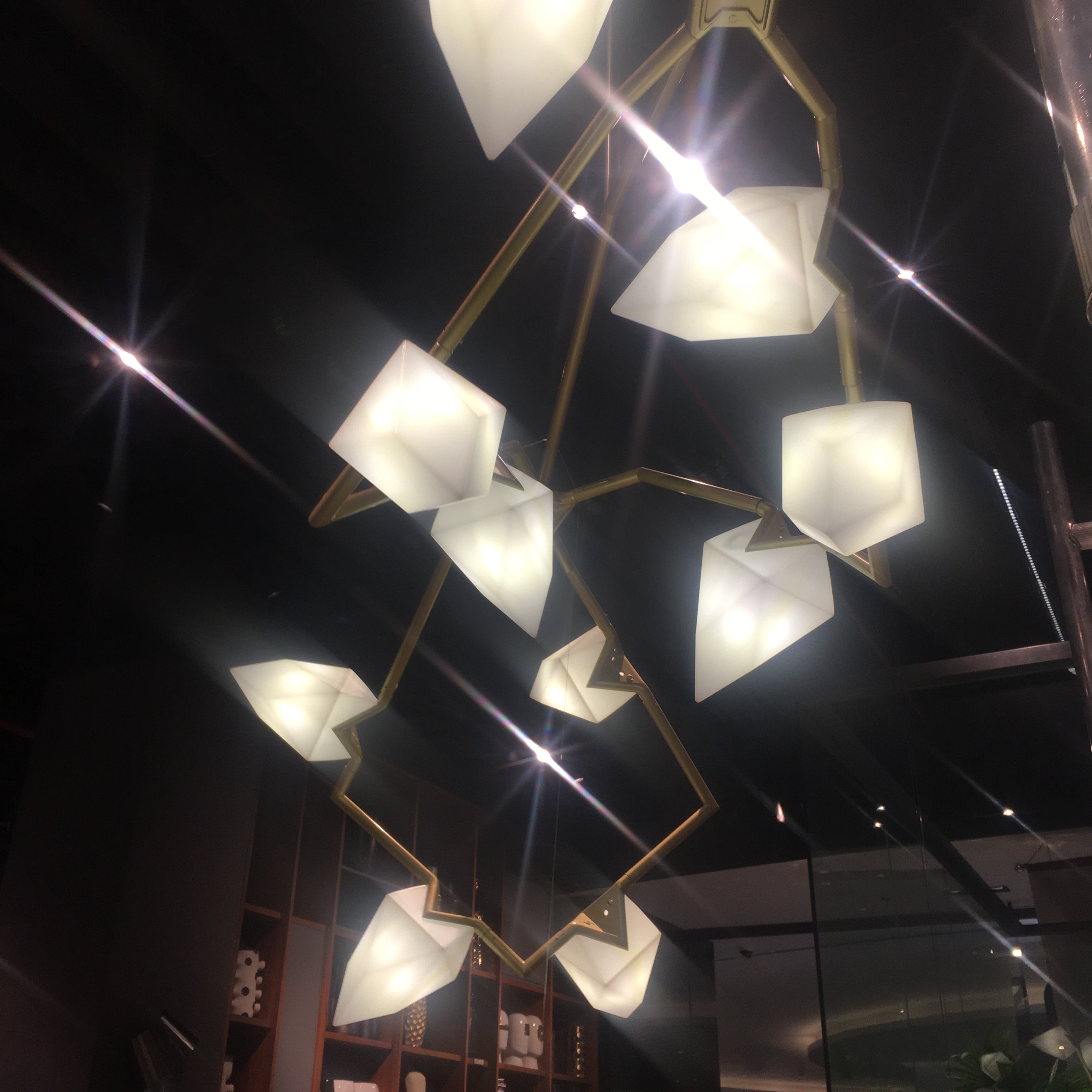 Display item showcasing the Masko 12-heads chandelier by Beacon with elegant design and multiple light fixtures.