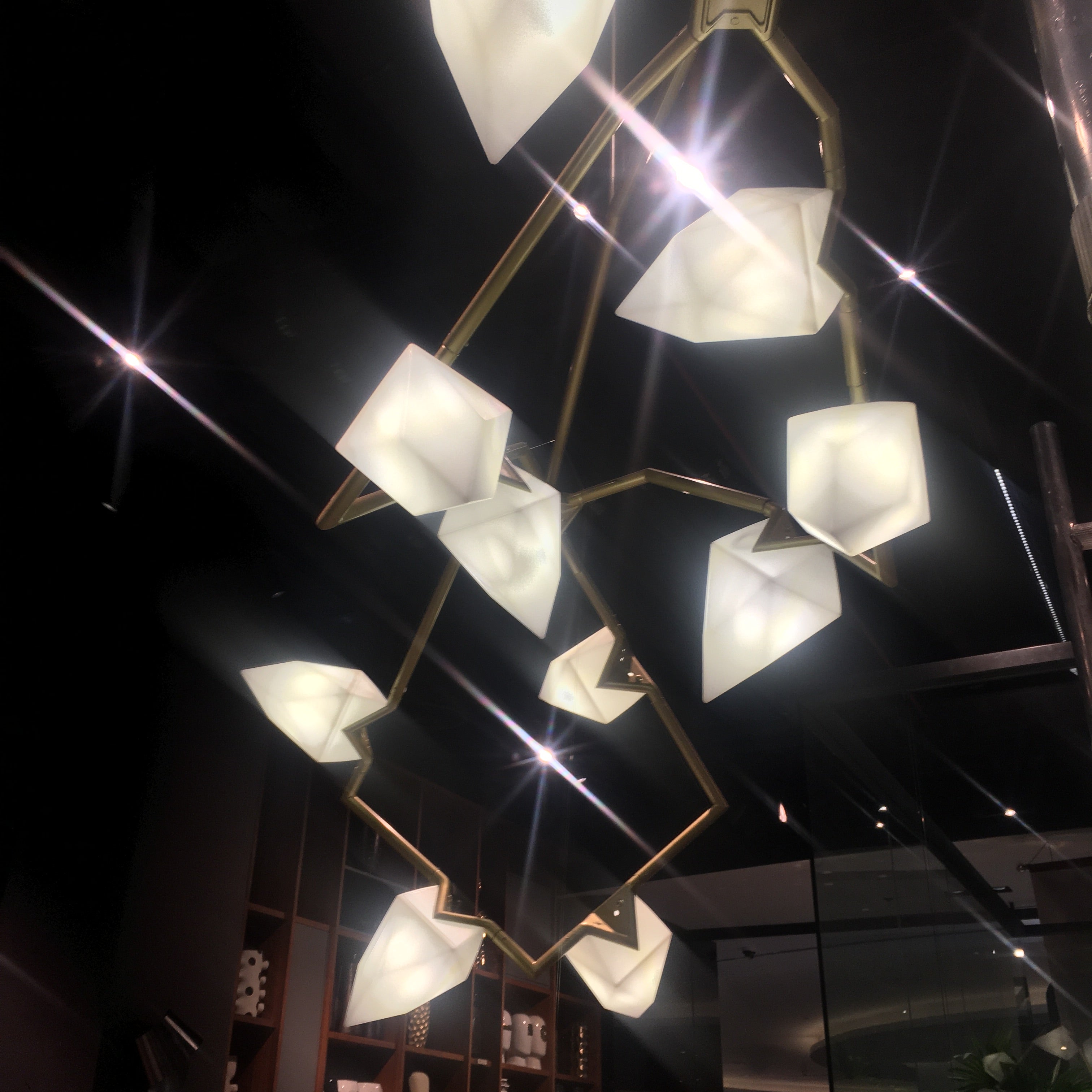 Display item of Masko 12-heads chandelier by Beacon, featuring a modern design with multiple hanging light fixtures.