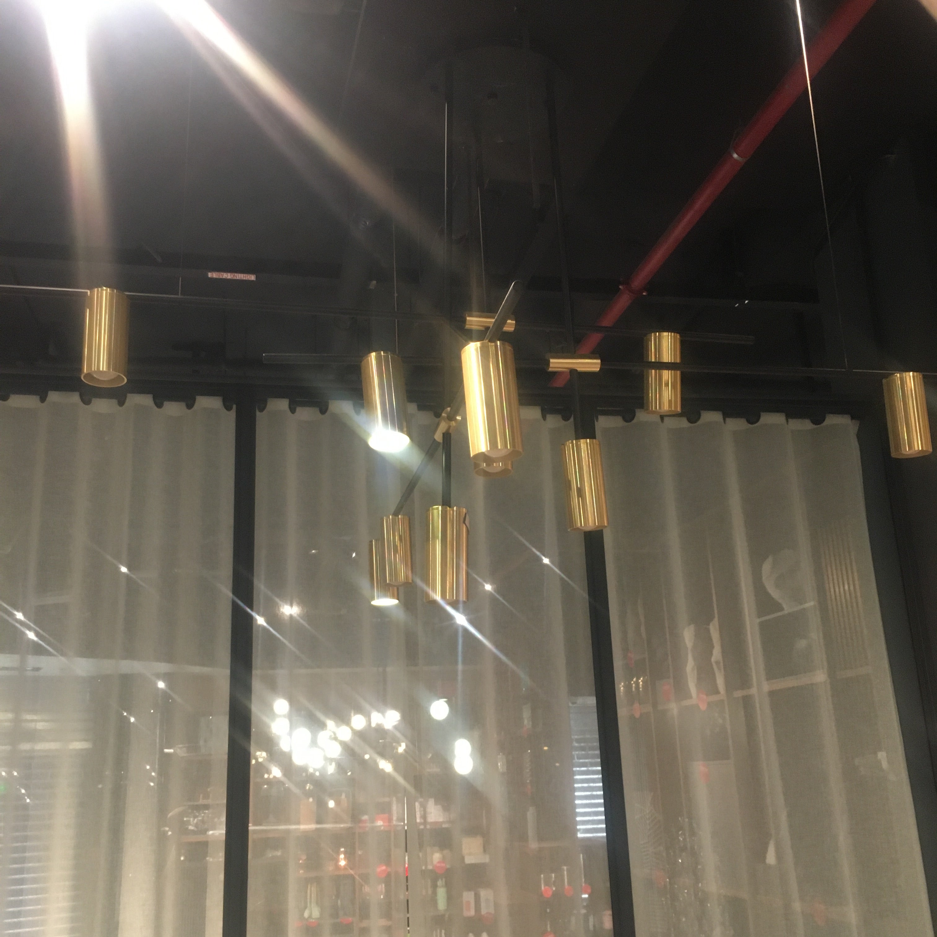 BEACON Monaco 12-heads pendant lamp with modern design, featuring sleek metal finish and multiple hanging light fixtures.