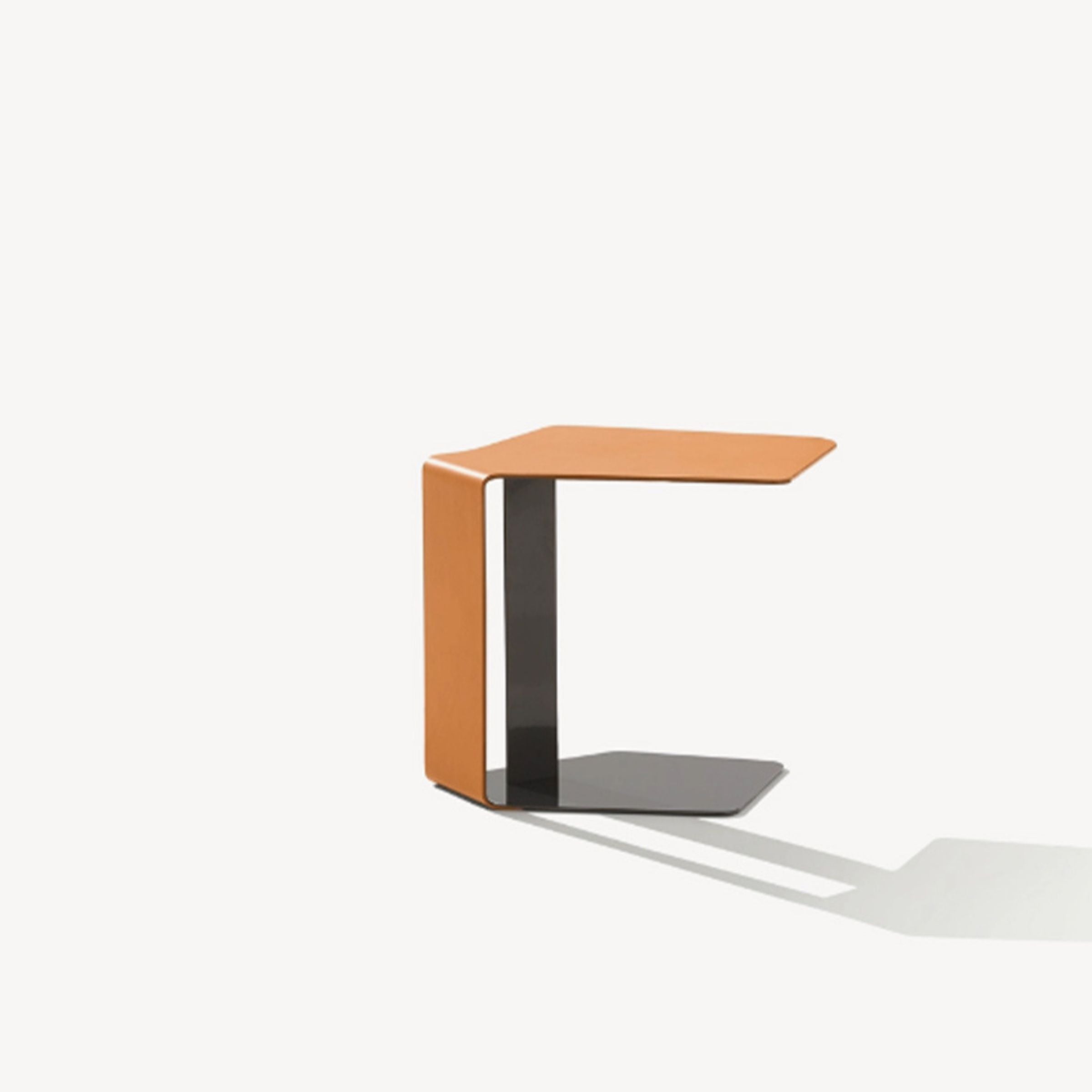 Mycroft Saddle Leather Side Table by BEACON featuring a sleek design with saddle leather surface and sturdy wooden legs.