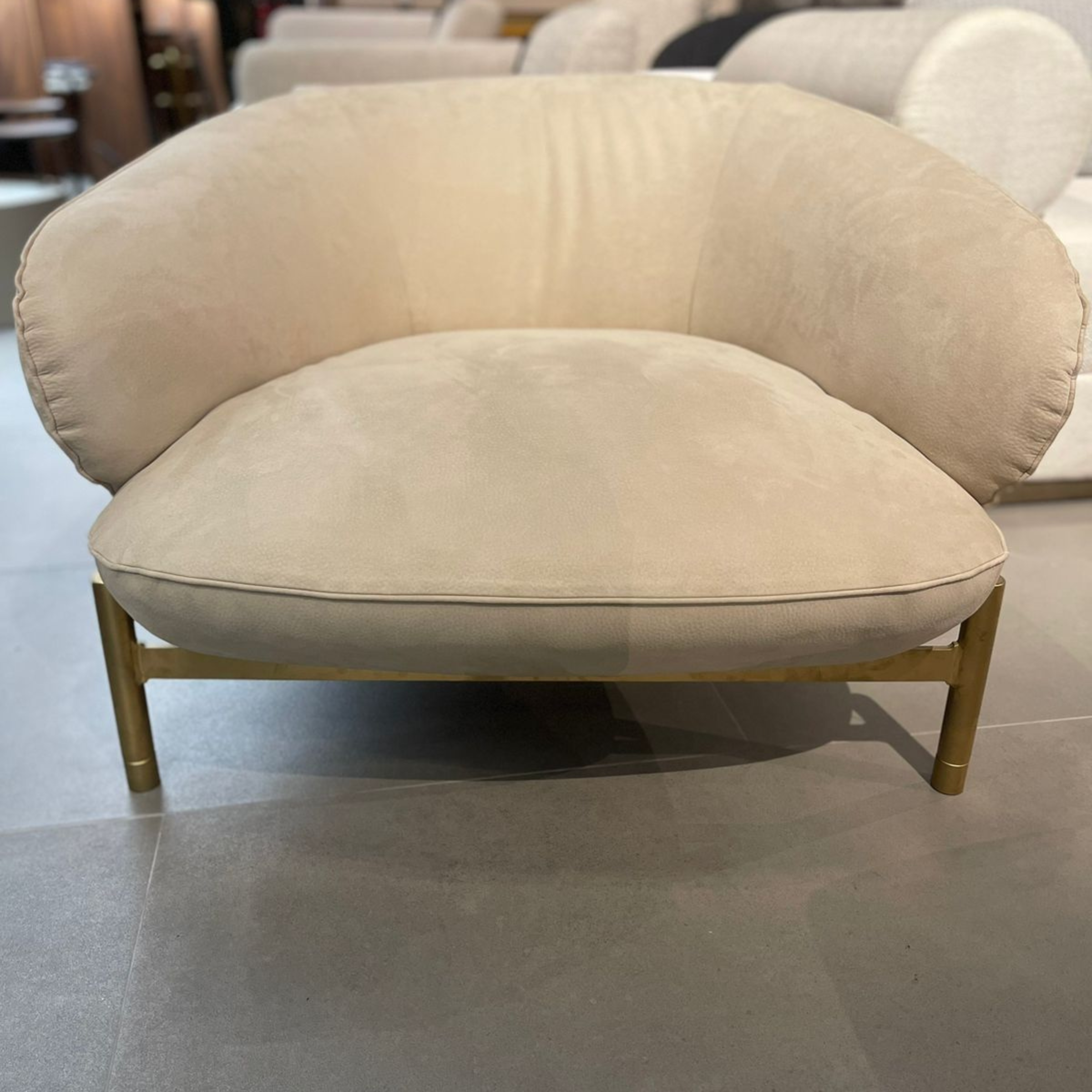 Display of the Next Armchair by HOMAGE KOLTUK, featuring modern design and soft upholstery in a showroom setting.