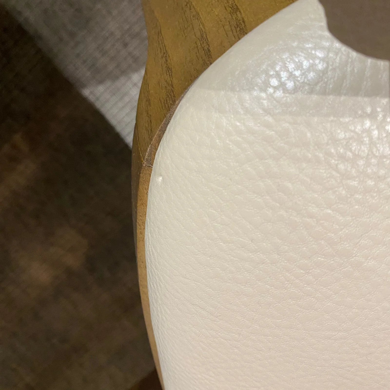 Display image of an OZZO Nirvana solid ash wood chair without arms, showcasing sleek wooden design and natural finish.