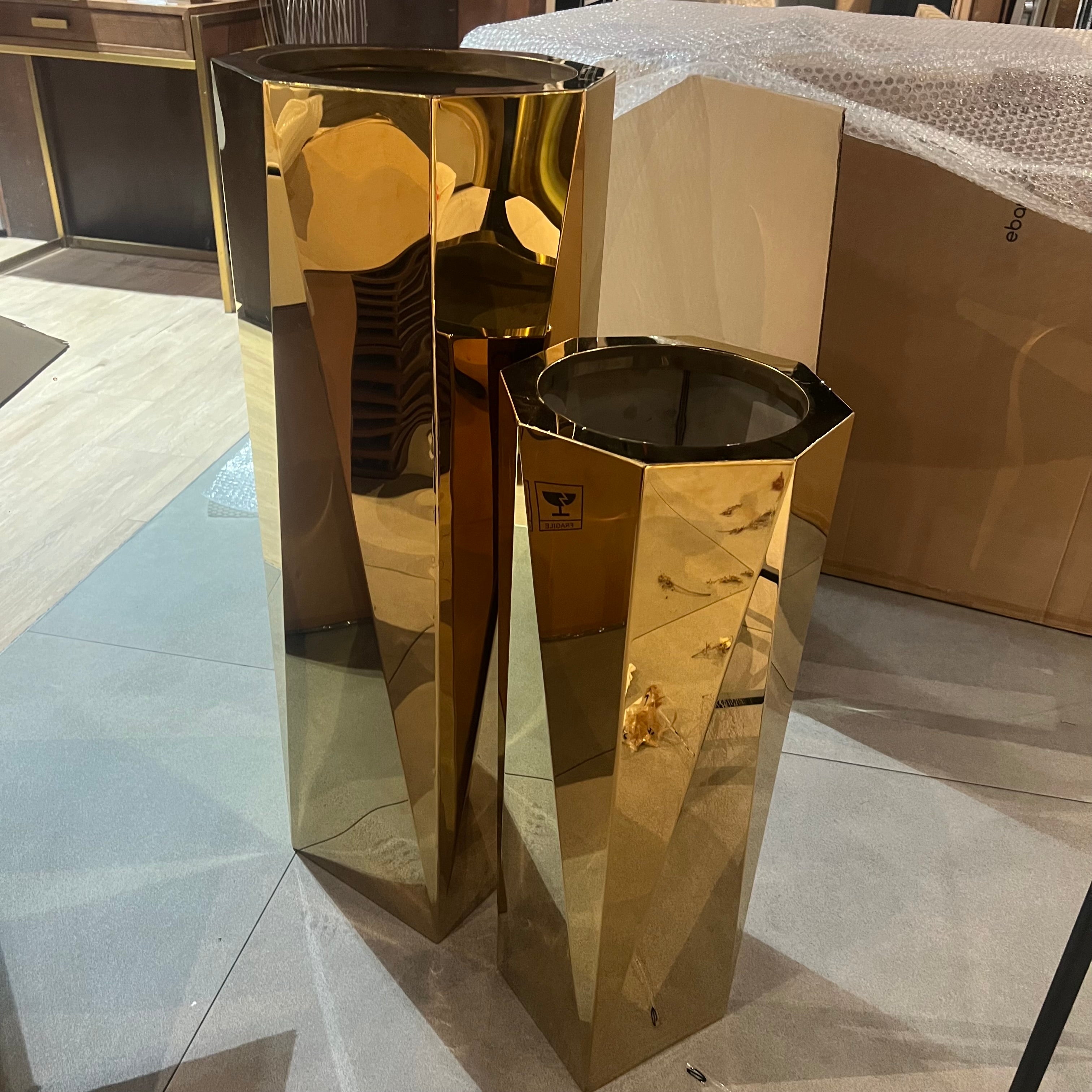 Set of three large stainless steel planter boxes with sleek, modern design, ideal for outdoor or indoor plant displays.