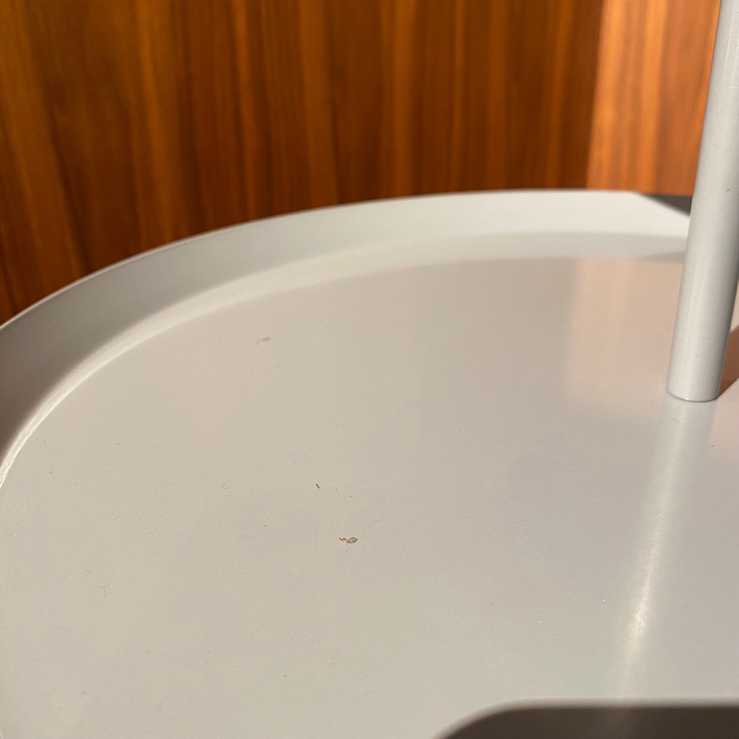 Steel side table GT-230DN by RUDI, display item with sleek design and sturdy metal construction, shown from a side angle.