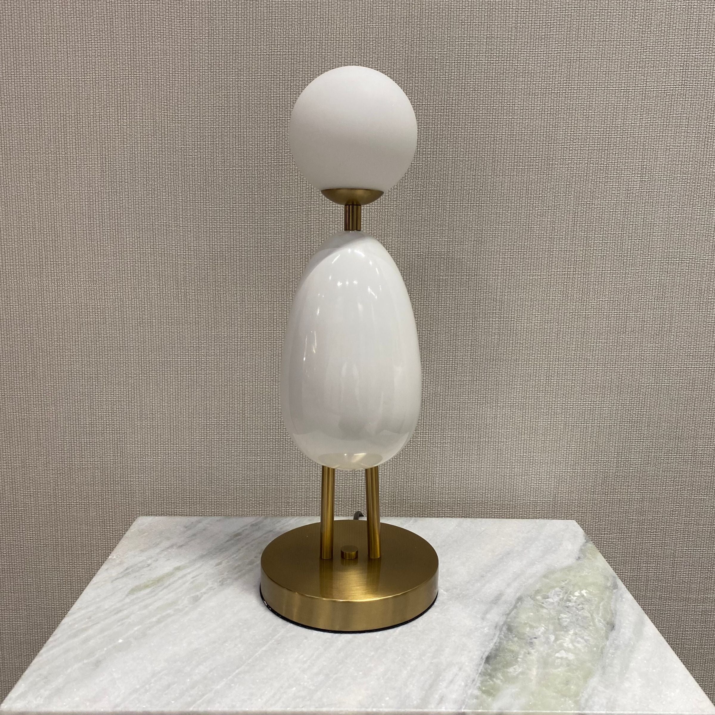 White BEACON desk table lamp model CY-LTD-1011-W with a modern design, shown on a display table.