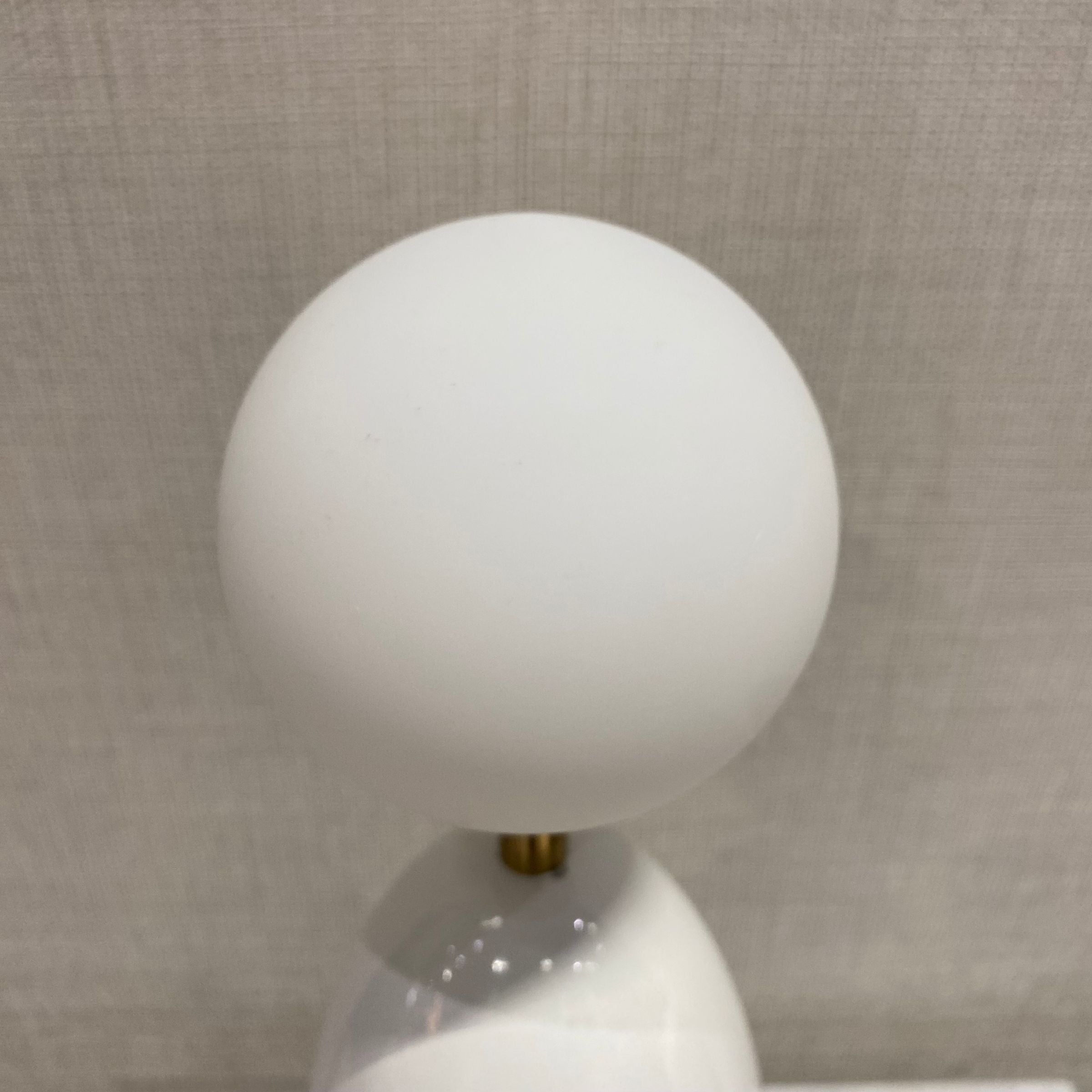White BEACON desk lamp model CY-LTD-1011-W with a modern design, displayed on a table for home or office lighting.